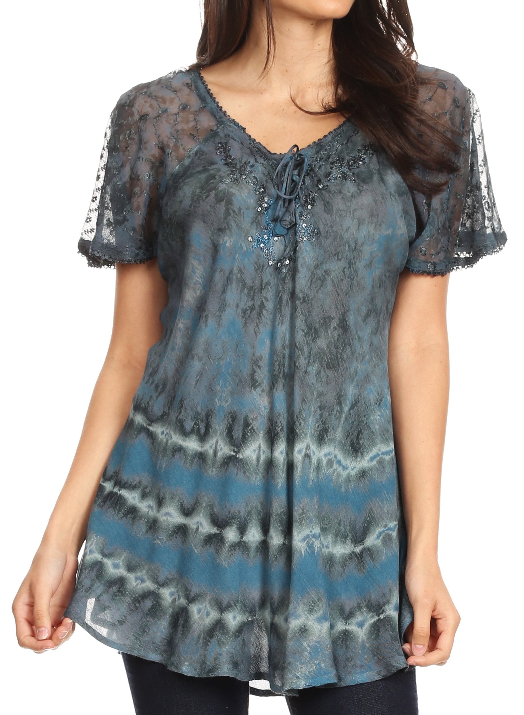 Woman wearing a blue and gray tie-dye top with lace details on a white background