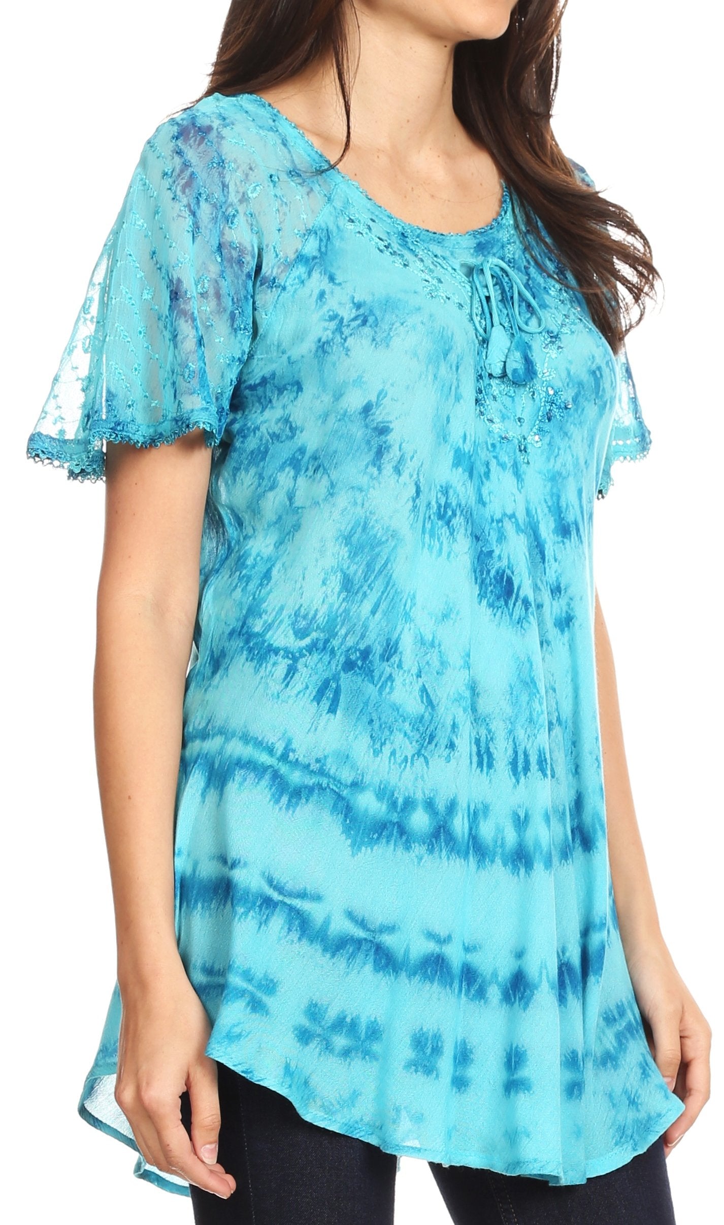 Woman wearing a blue tie-dye top with sheer sleeves on a white background