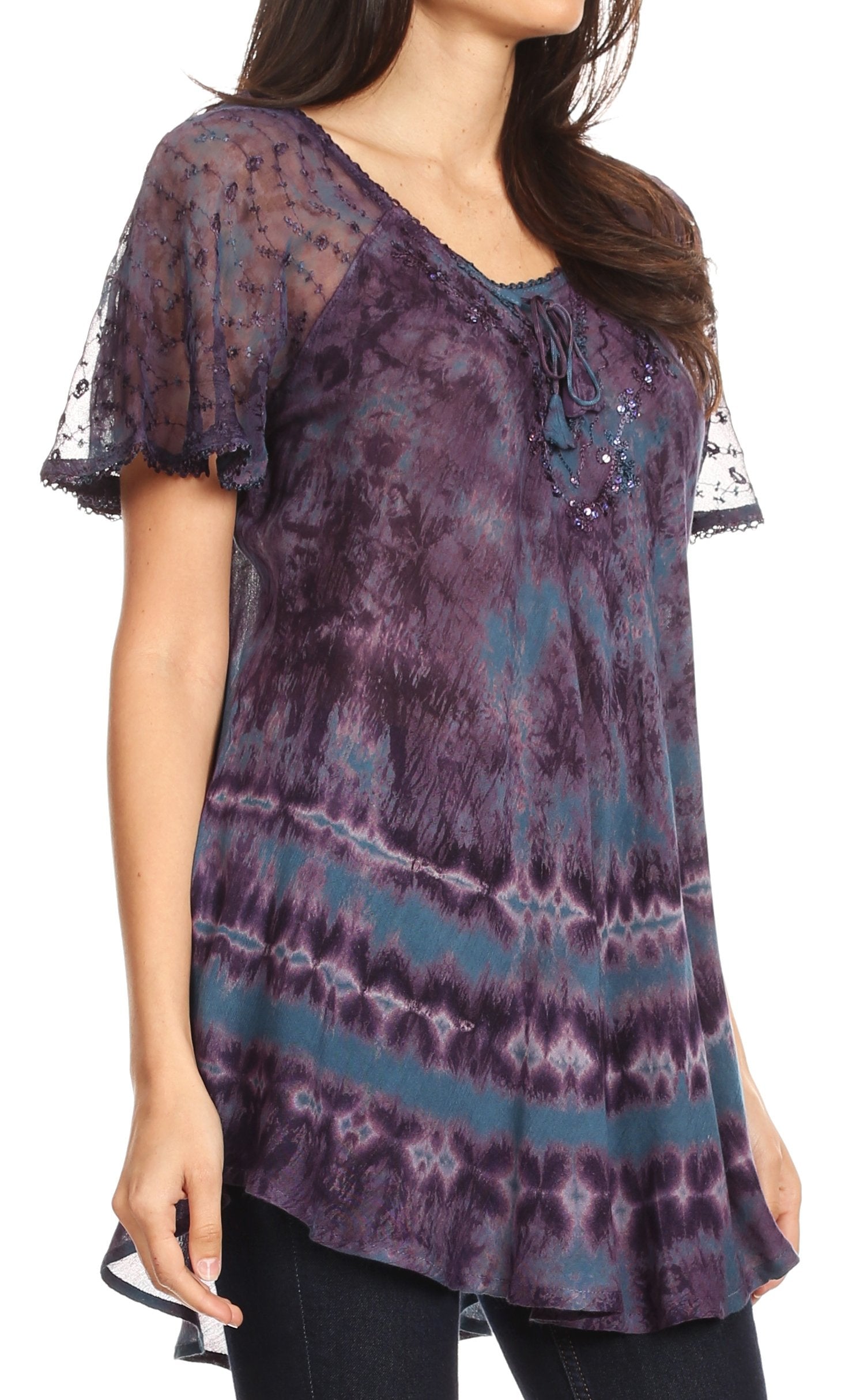 Woman wearing a tie-dye shirt with sheer sleeves on a white background