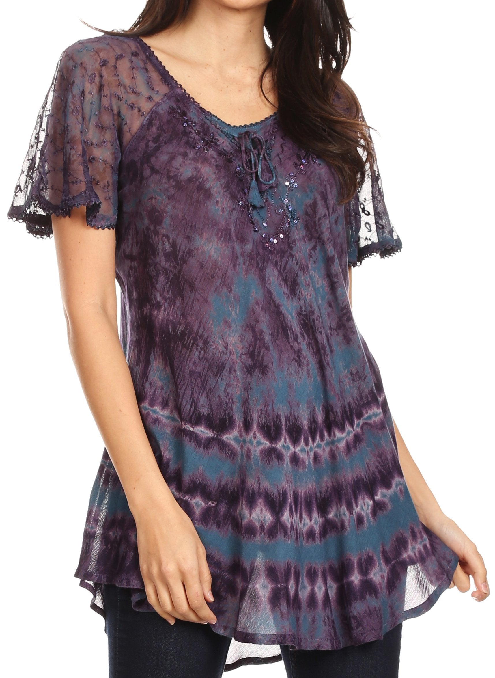 Woman wearing a tie-dye top with lace sleeves on a white background