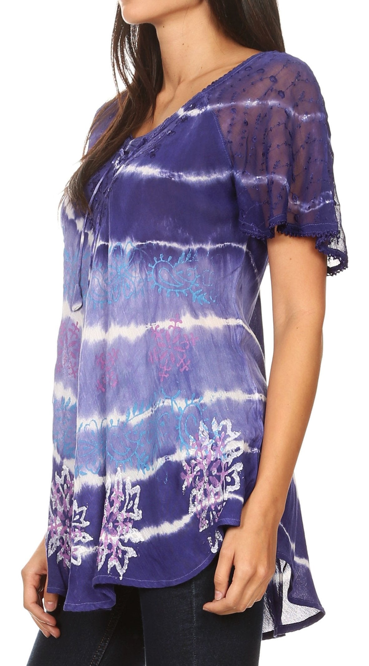 Woman wearing a purple tie-dye shirt with floral patterns on a white background