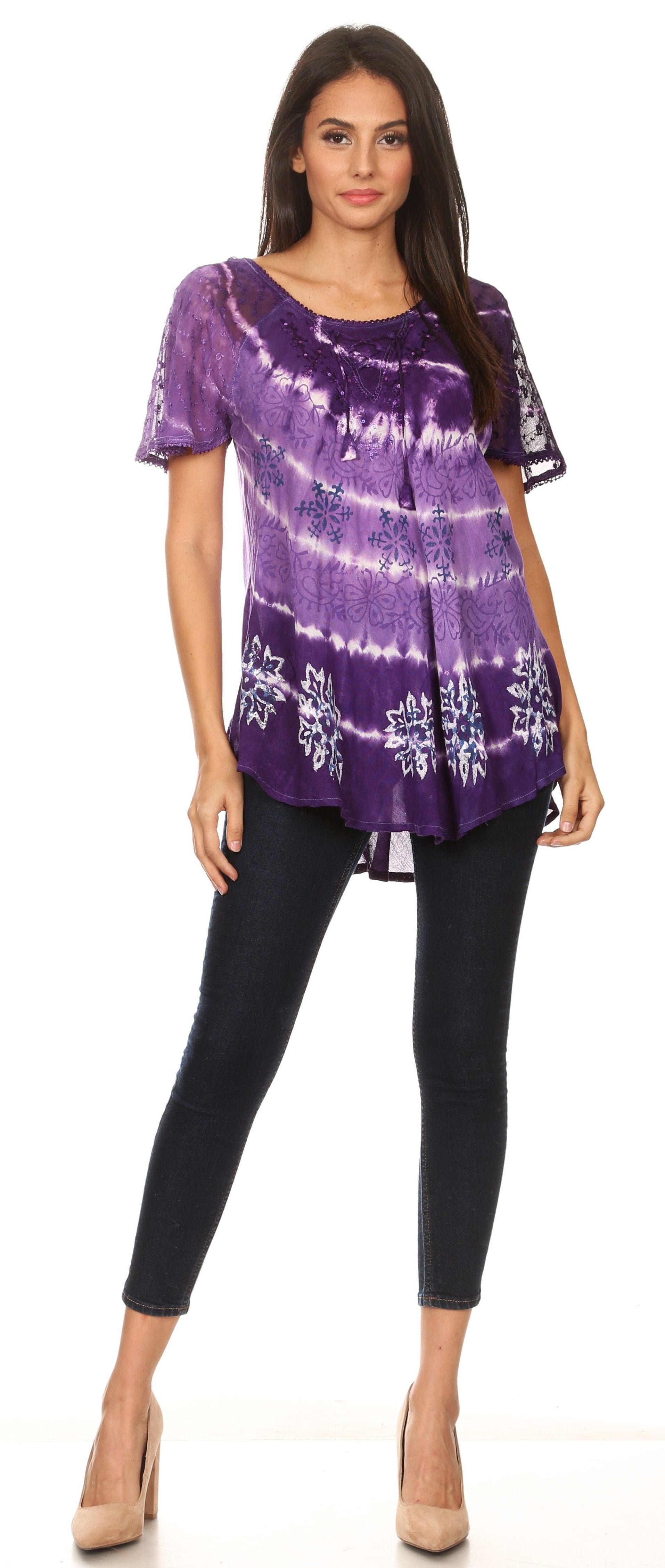 Woman wearing a purple tie-dye top and black pants on a white background