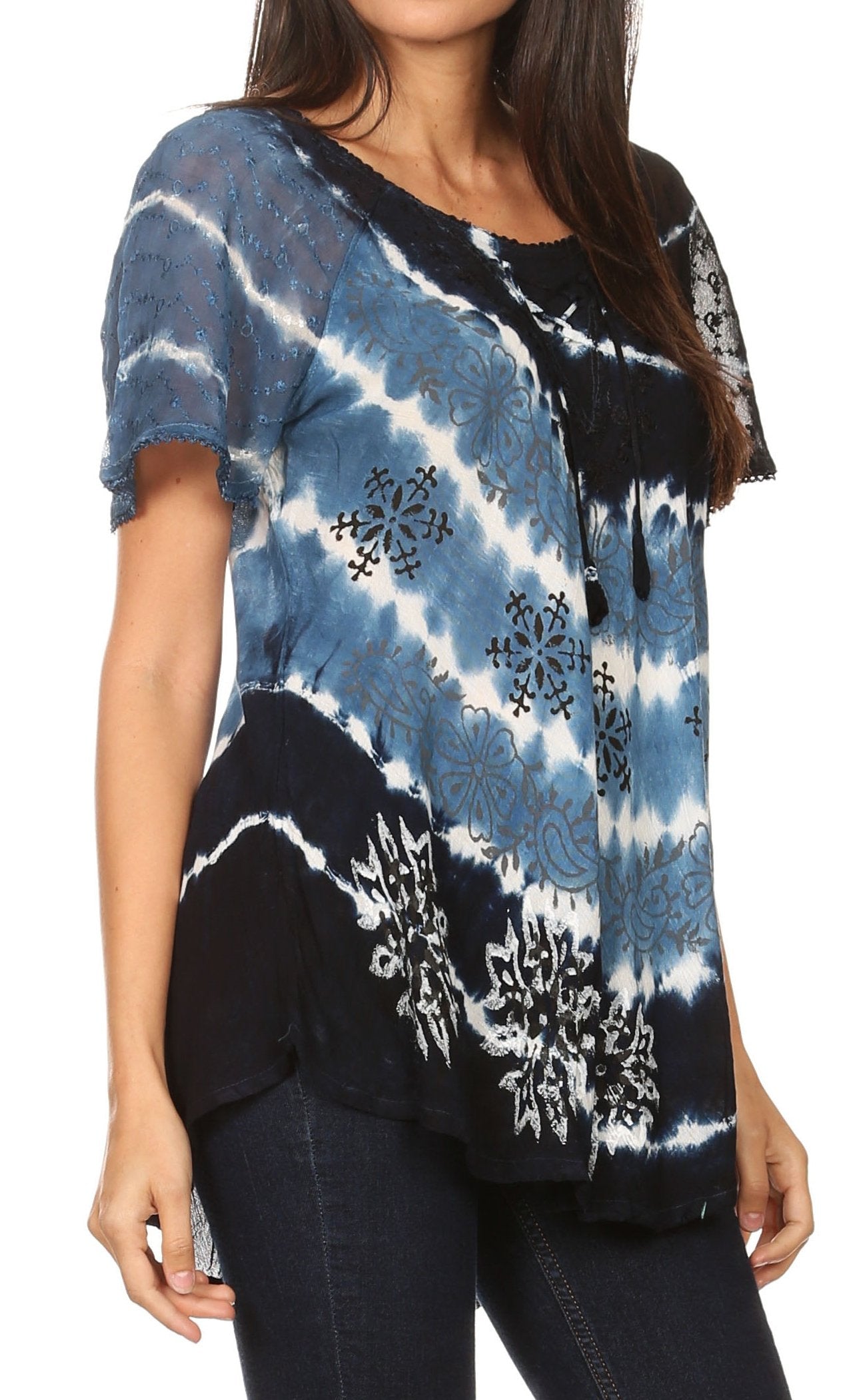 Woman wearing a tie-dye shirt with black, blue, and white patterns.