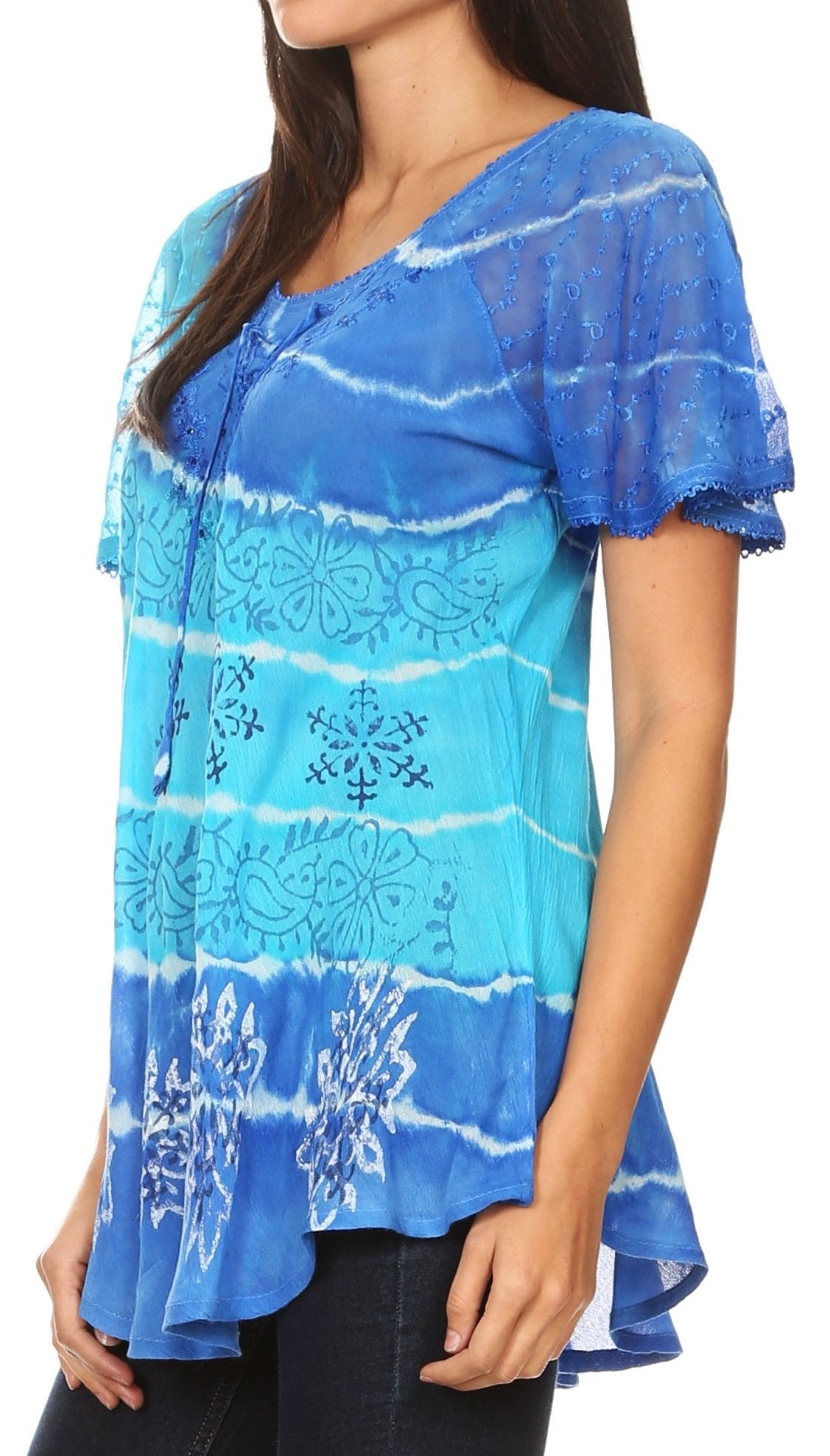 Woman wearing a blue tie-dye blouse with floral patterns on a white background