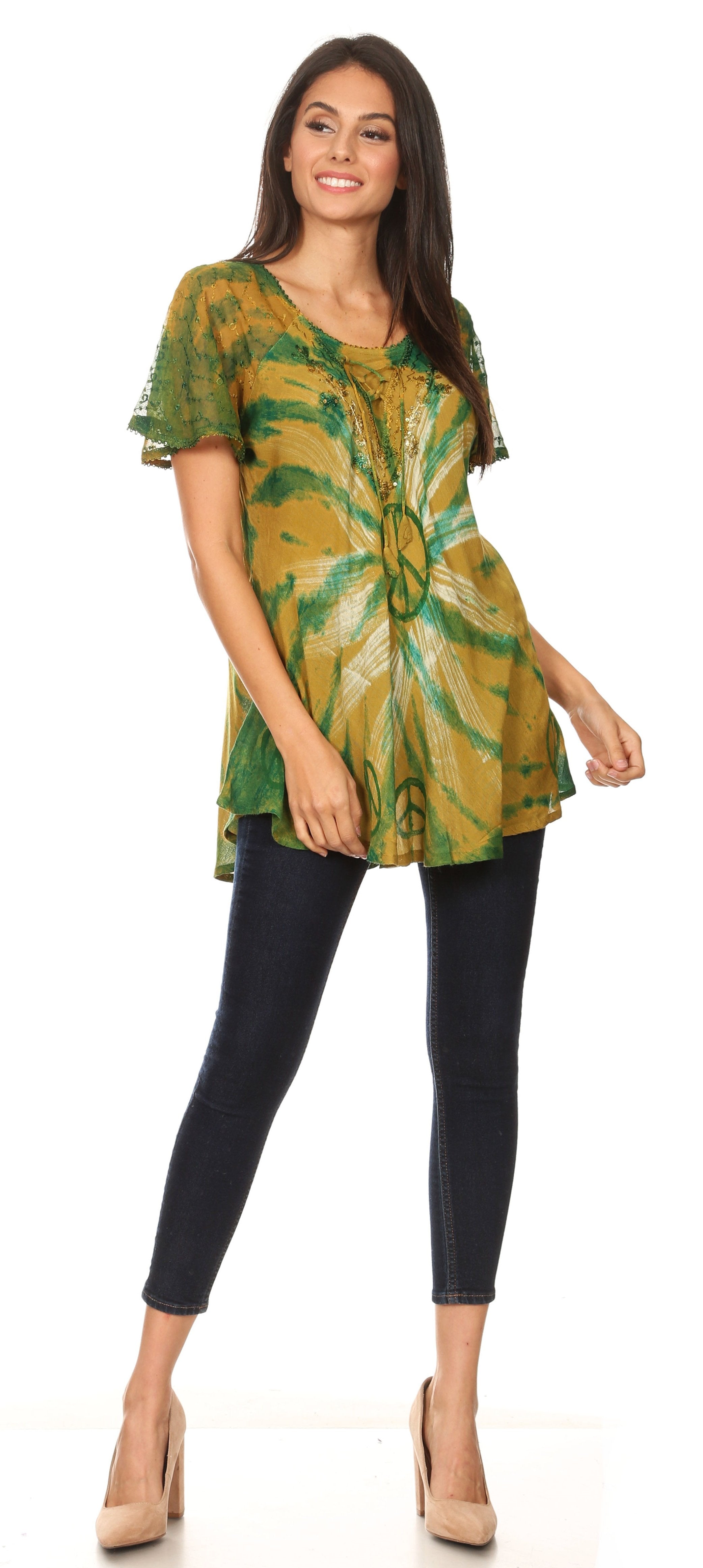 Woman wearing a green tie-dye top and black pants on a white background