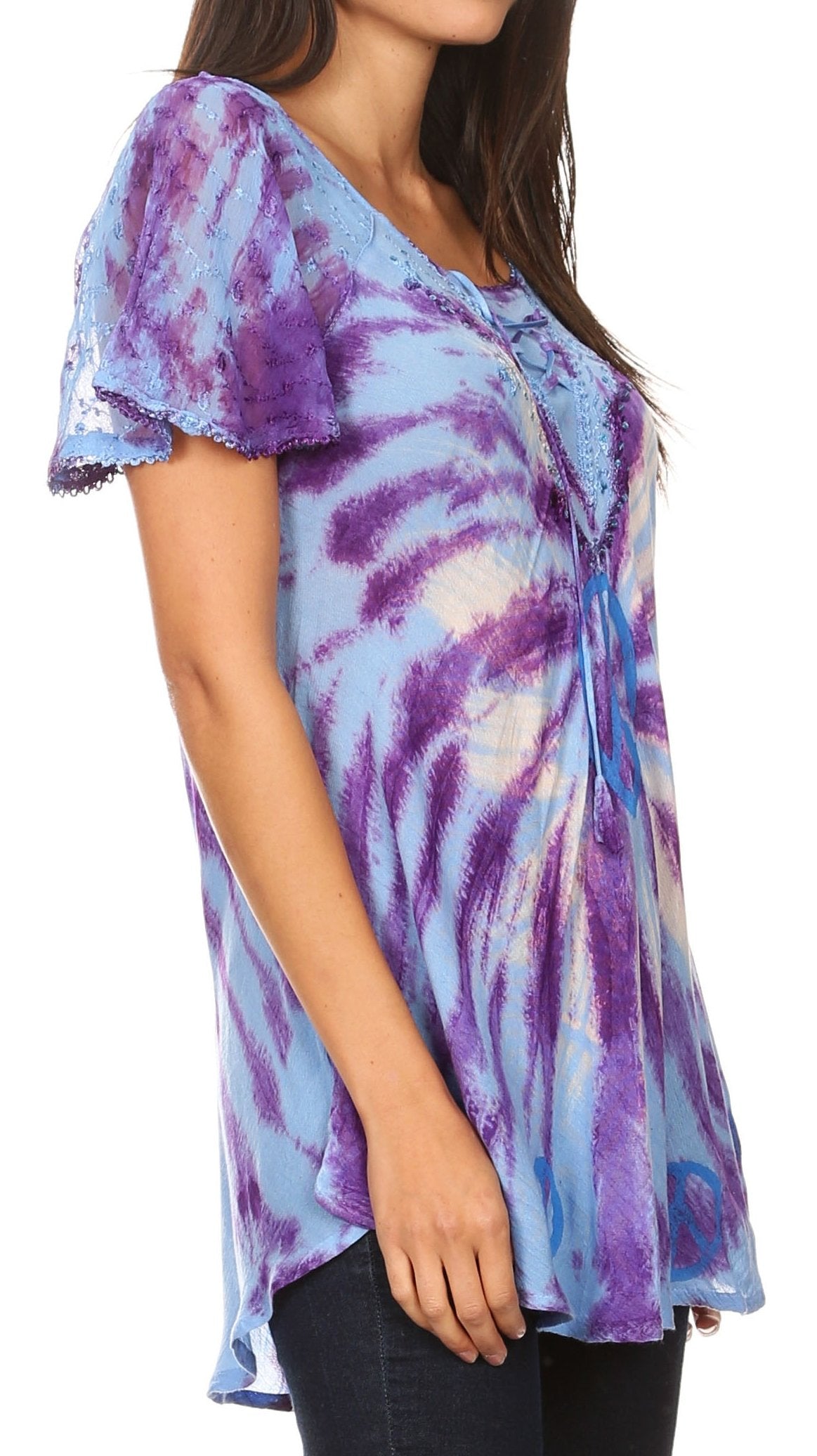 Woman wearing a tie-dye shirt with purple and blue patterns on a white background