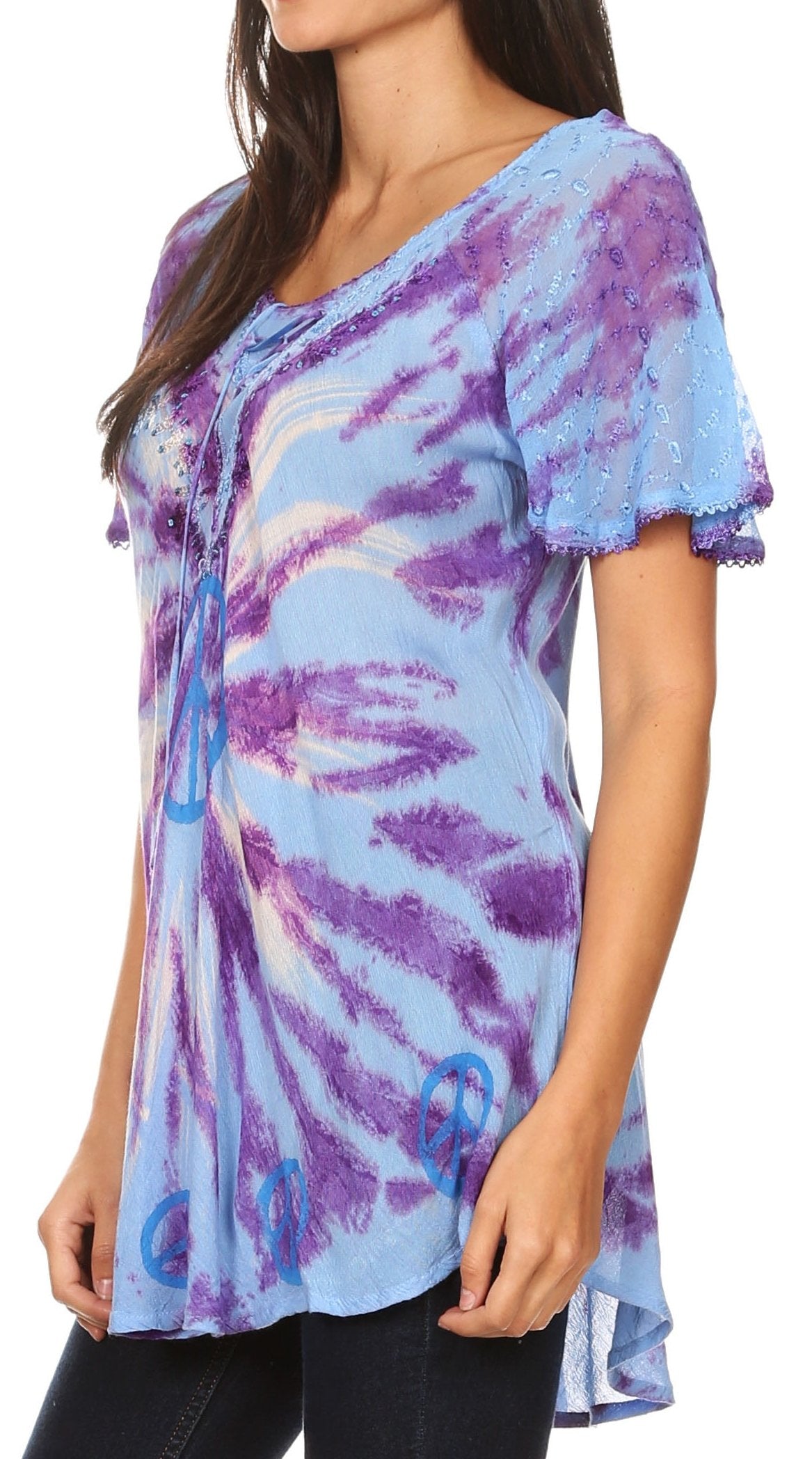 Woman wearing a tie-dye shirt with blue and purple patterns on a white background