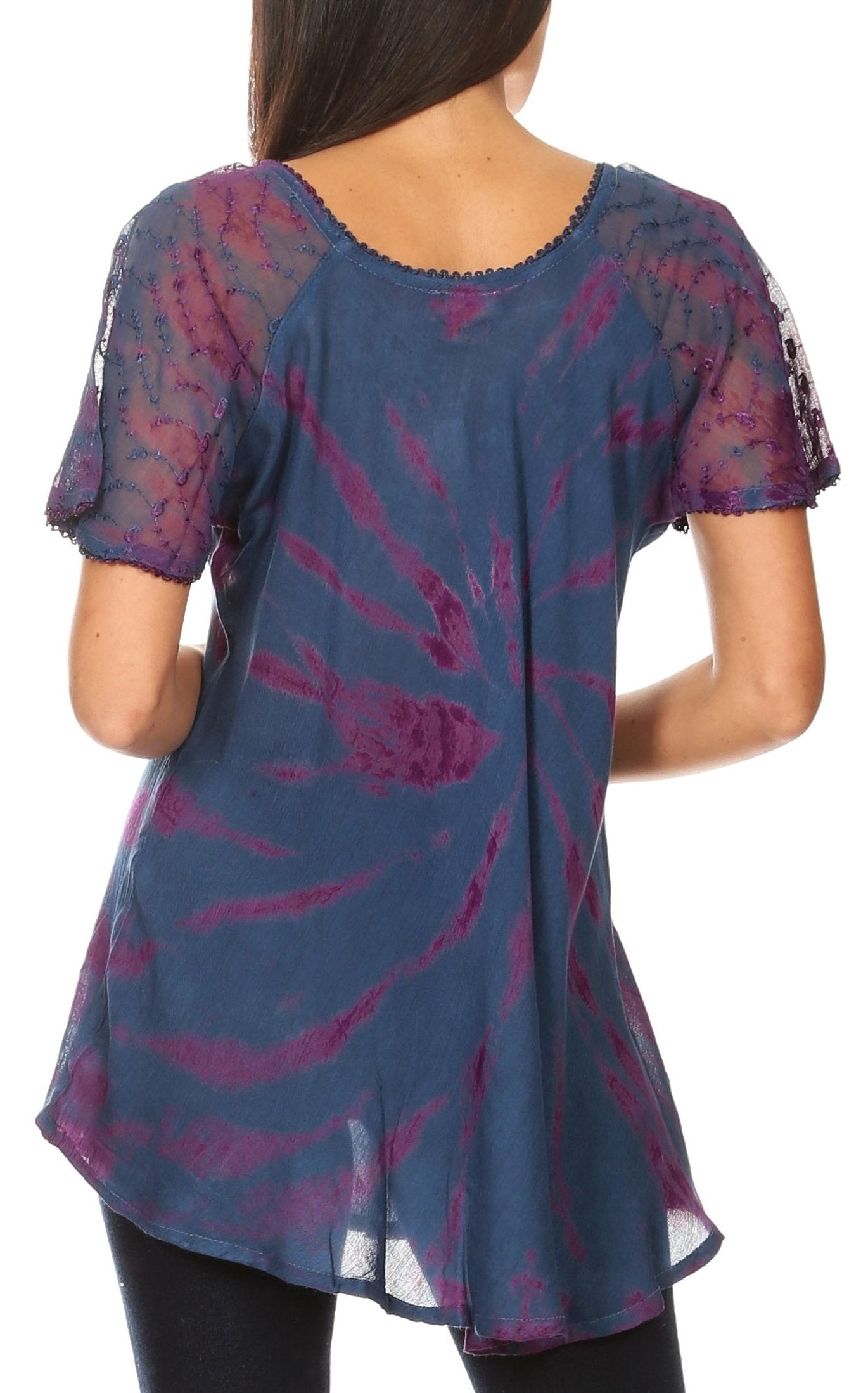 Blue and purple patterned tunic worn by a person on a white background