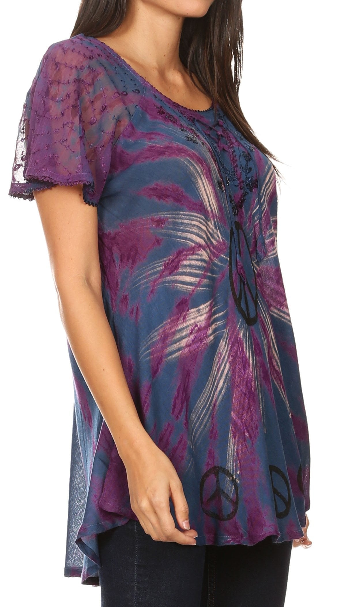 Woman wearing a colorful tunic with peace symbol design on a white background