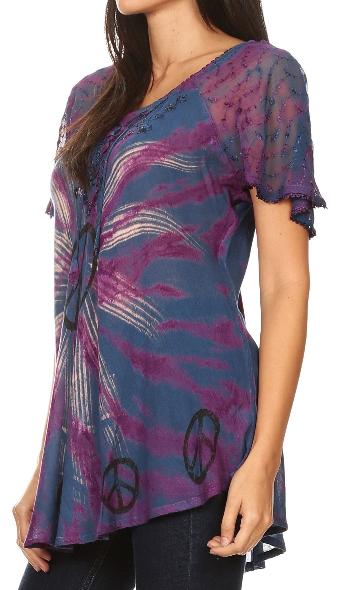 Woman wearing a blue and purple patterned top with peace signs on a white background