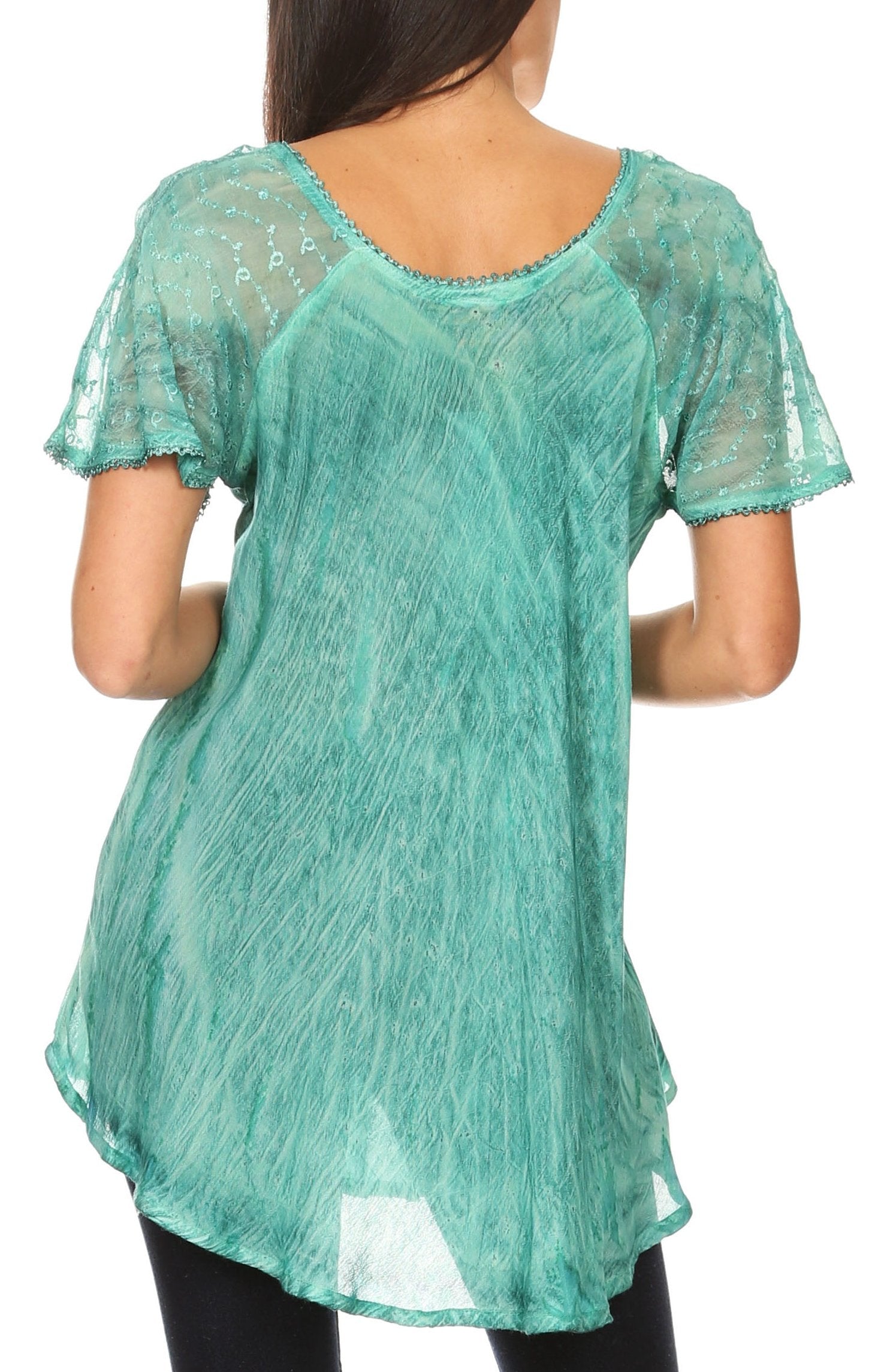 Green lace top worn by a person on a white background