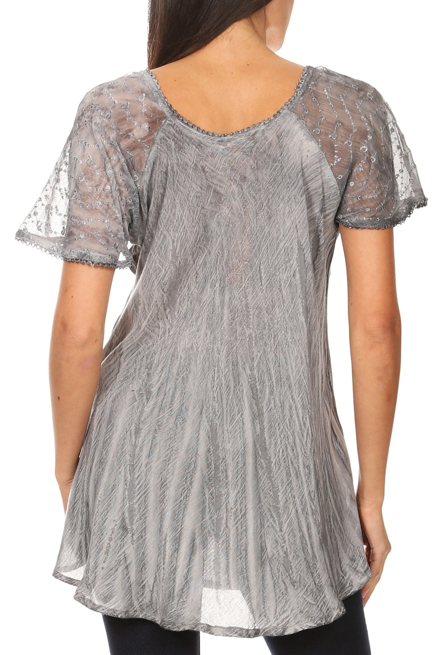 Woman wearing a sheer gray lace top on a white background