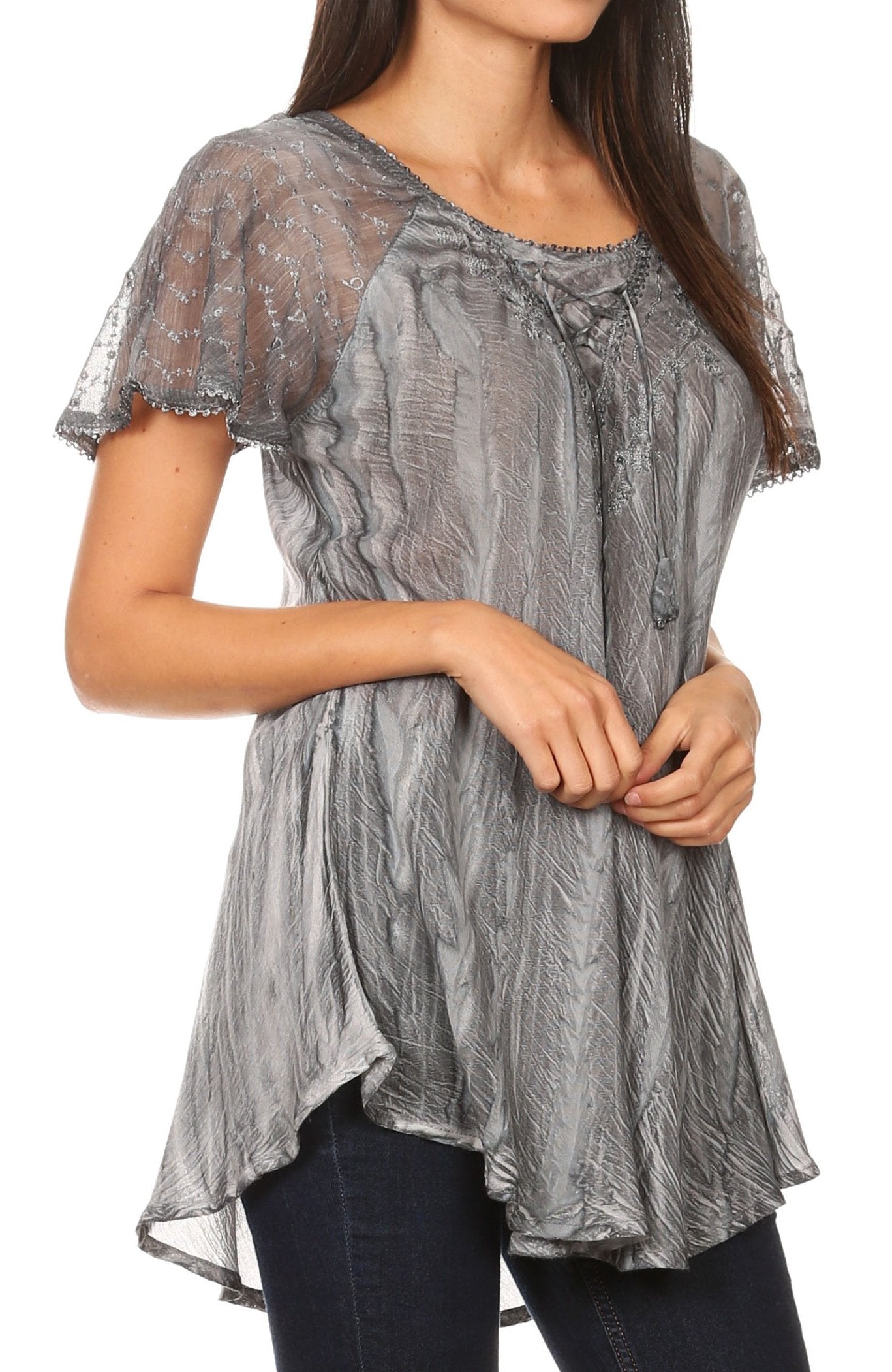Woman wearing a gray sheer top with a white background