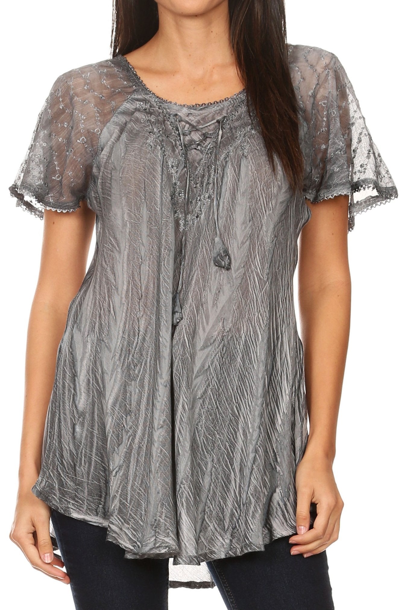 Woman wearing a sheer gray blouse with lace details on a white background