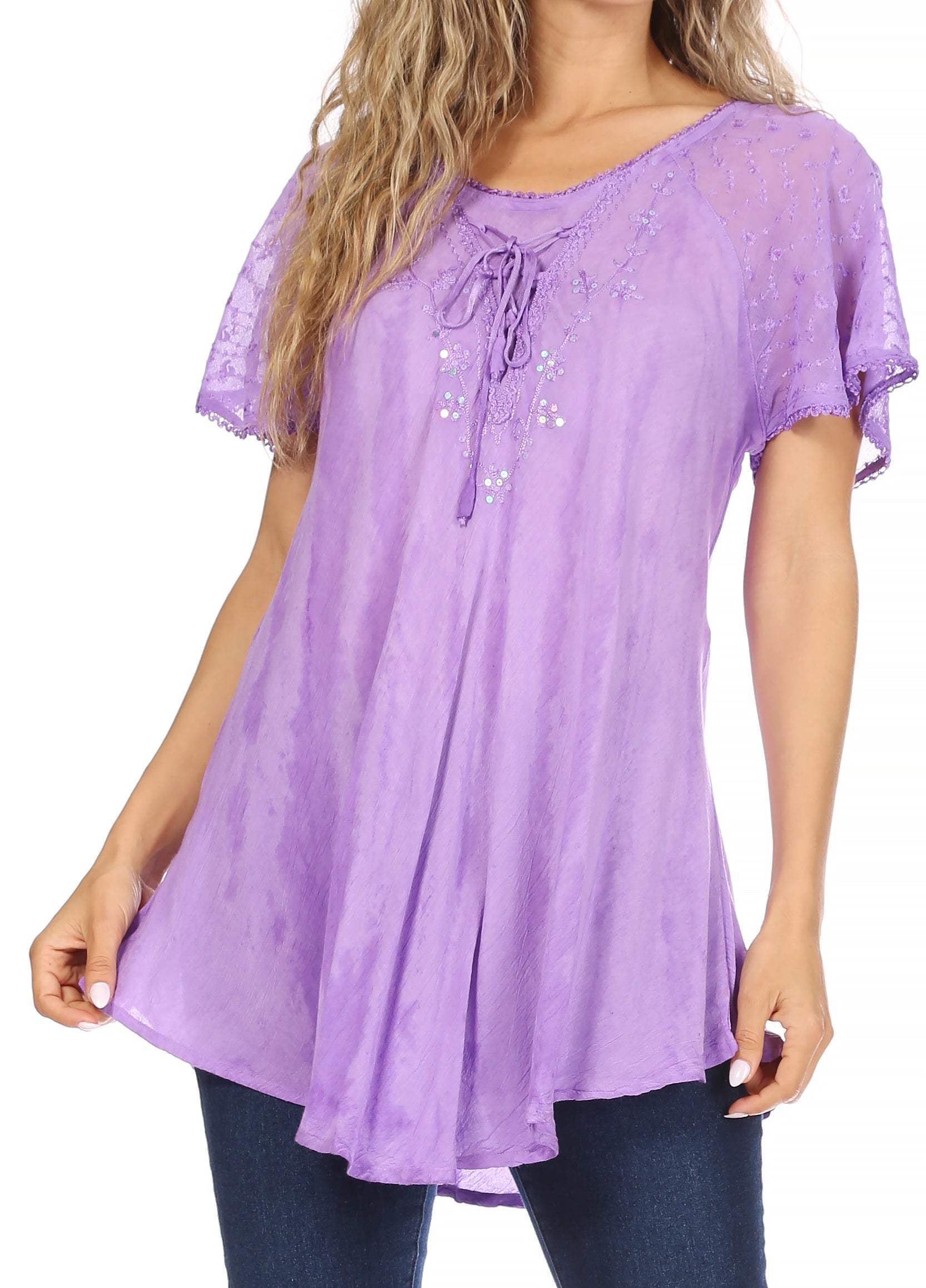 Woman wearing a purple lace-trimmed blouse with a white background