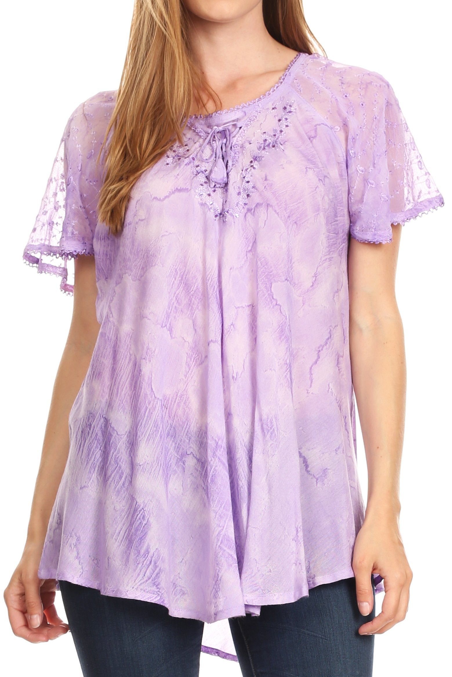 Woman wearing a purple floral blouse with ruffled sleeves on a white background