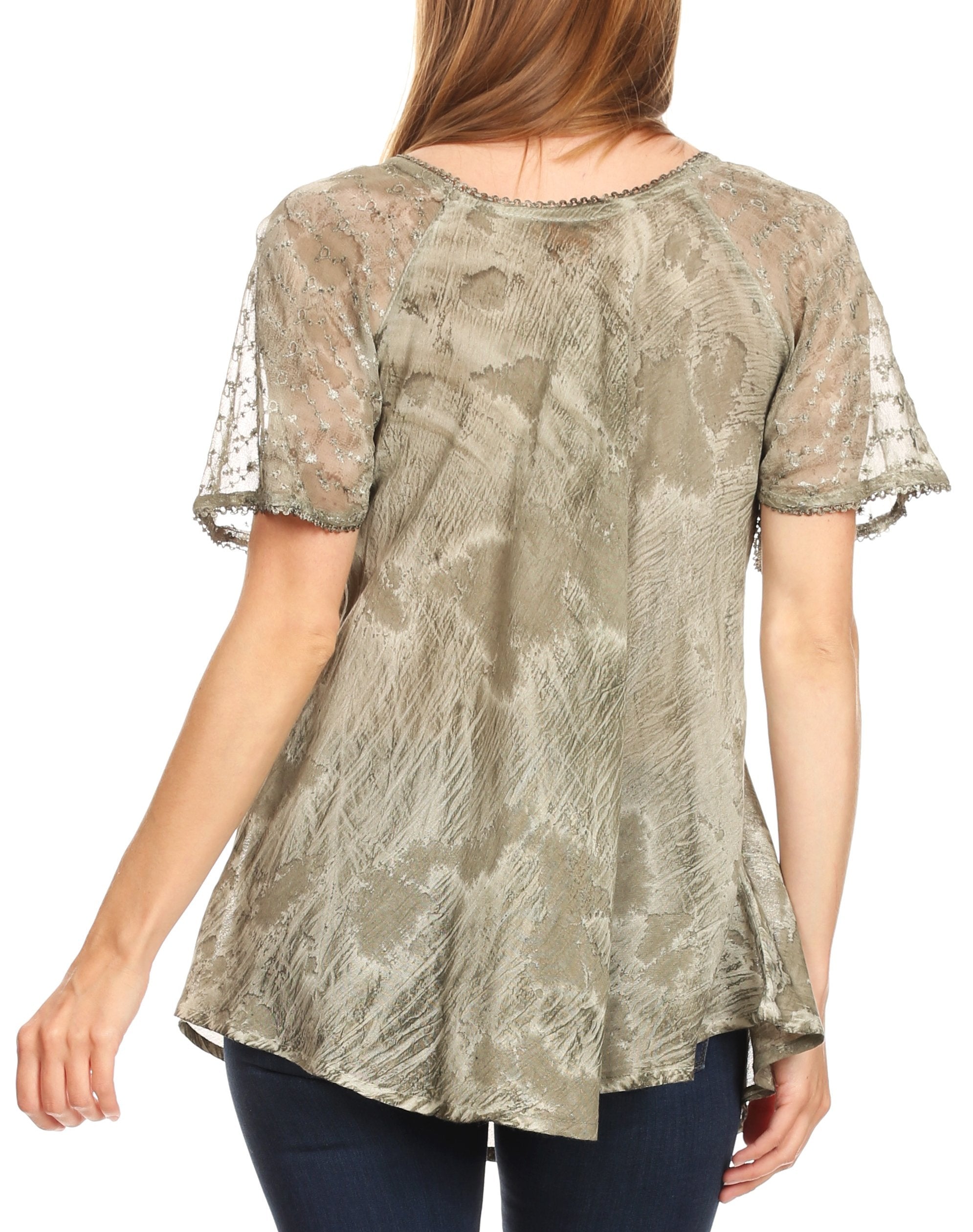 Woman wearing a sheer lace top with a white background