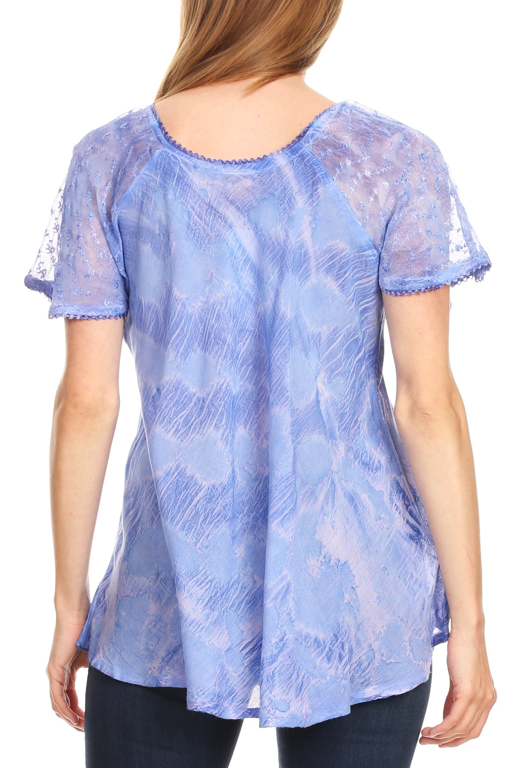 Woman wearing a blue lace top with a white background