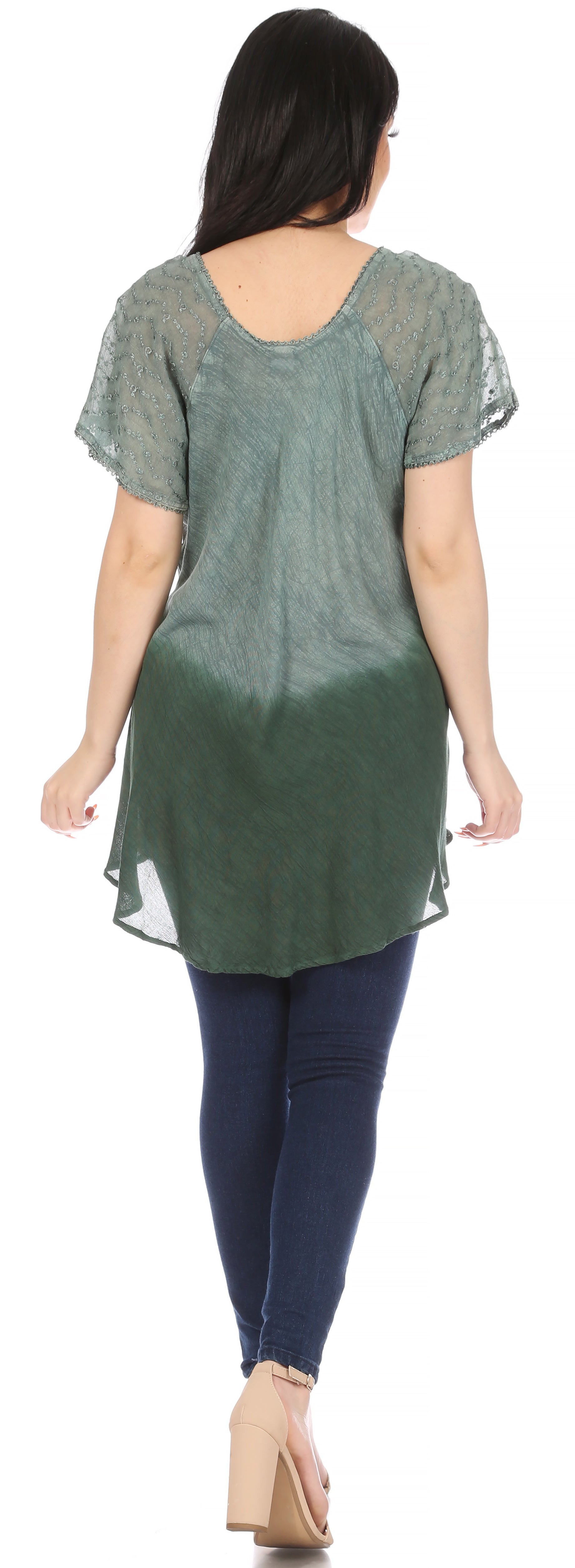 Woman wearing a green gradient top and blue pants on a white background