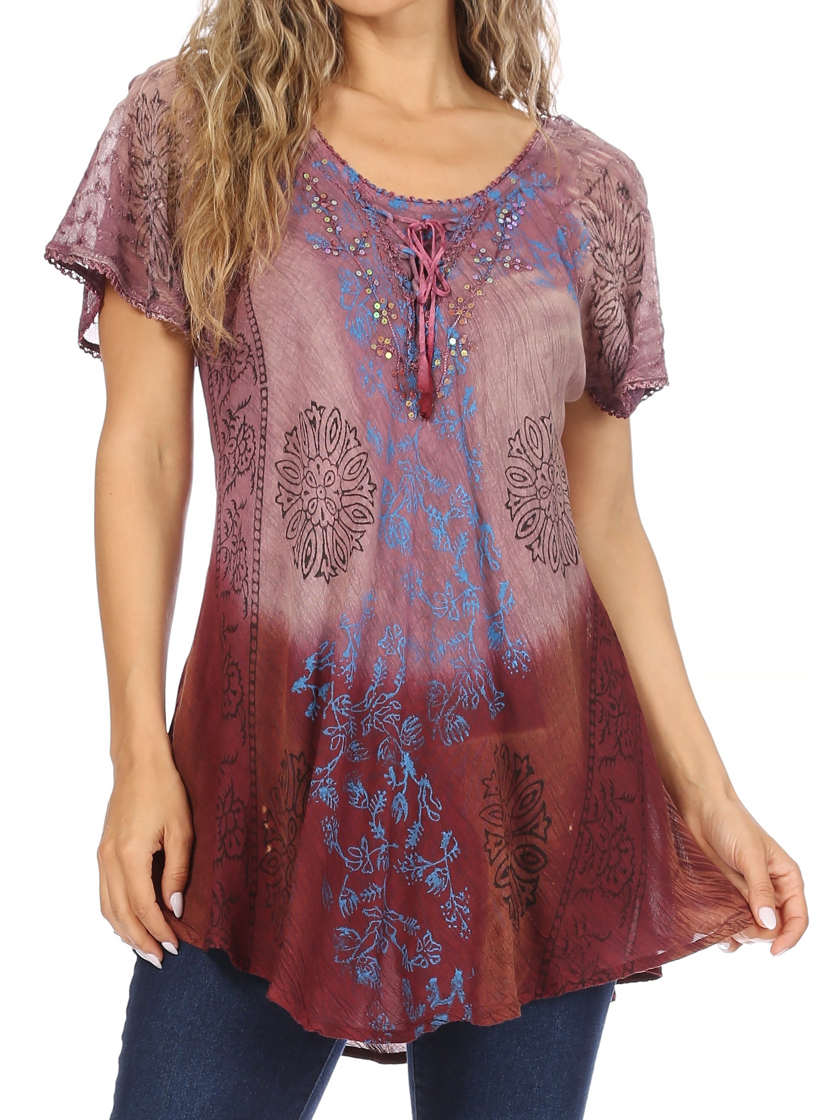 Woman wearing a patterned blouse with a gradient design on a plain background