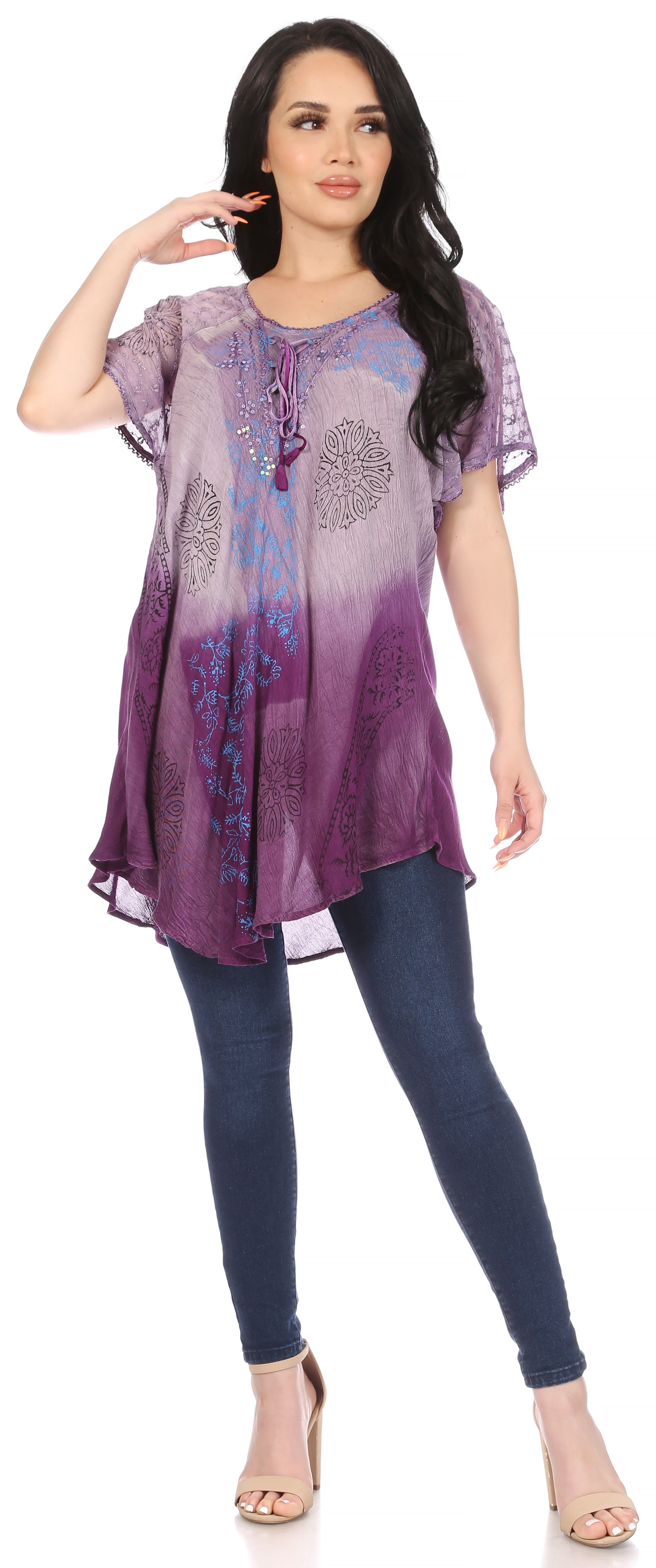 Woman wearing a purple and blue gradient top with blue leggings on a white background