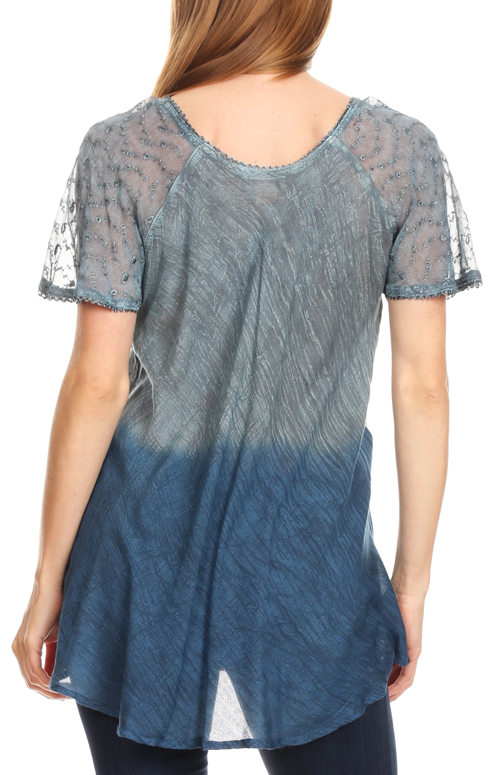 Woman wearing a blue and gray gradient top with sheer sleeves on a white background