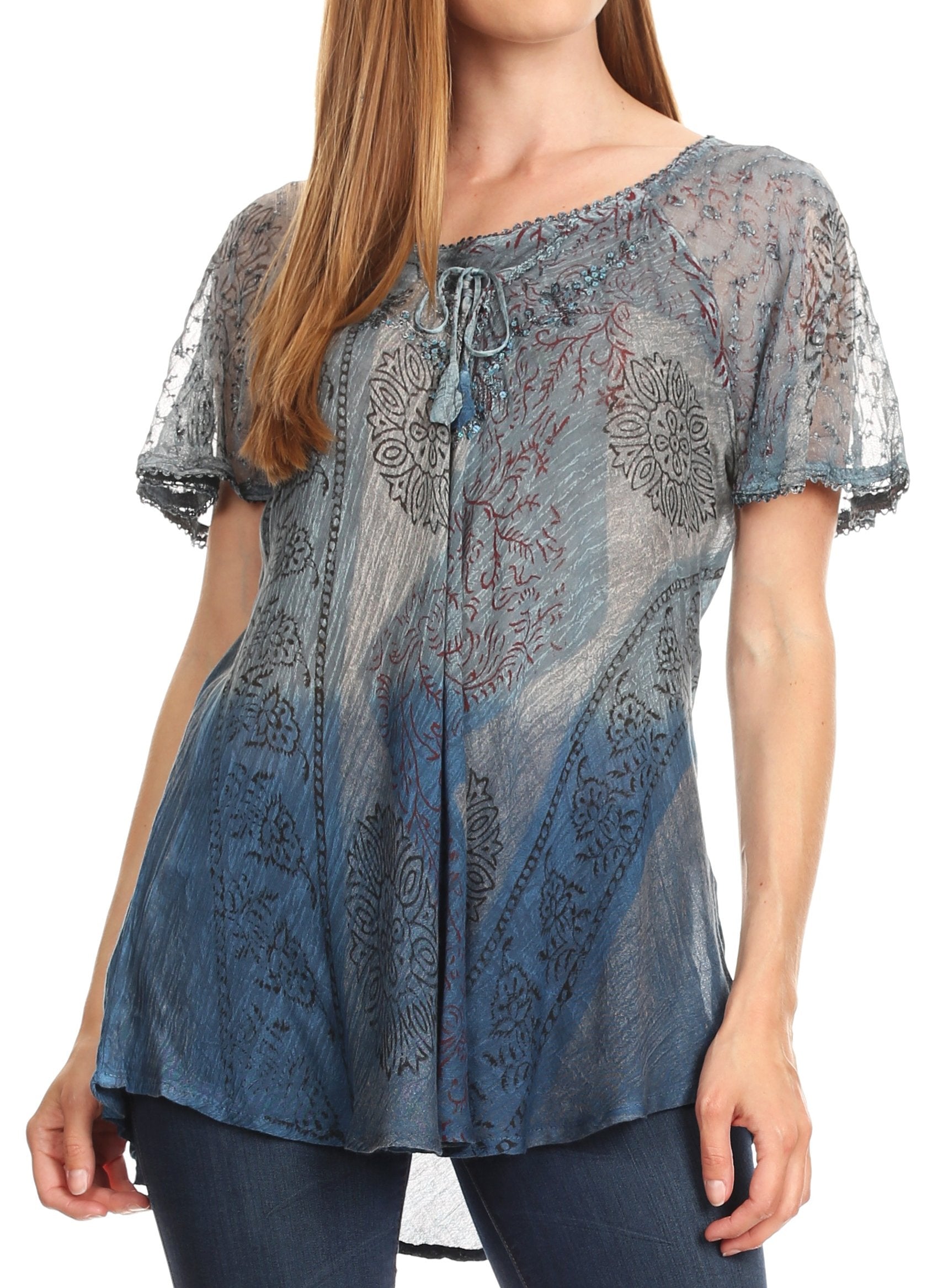 Woman wearing a blue patterned blouse with sheer sleeves on a white background