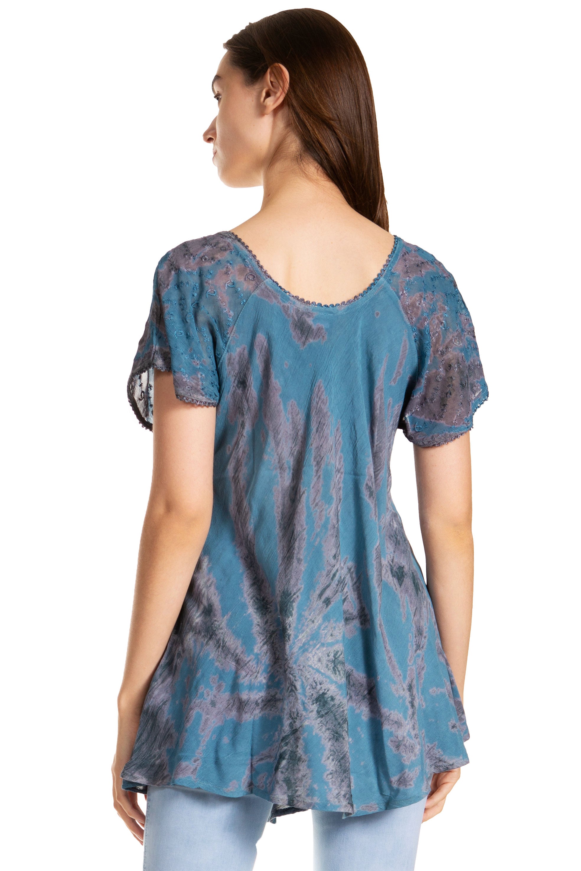 Woman wearing a blue patterned top on a white background
