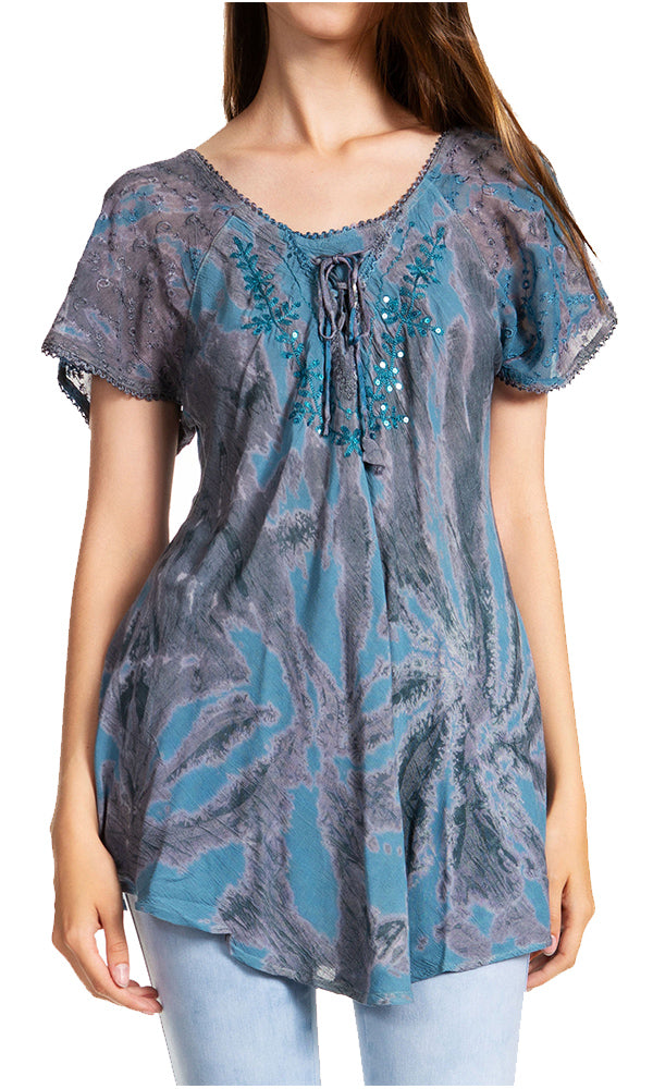 Woman wearing a blue and gray patterned top with lace details on a white background