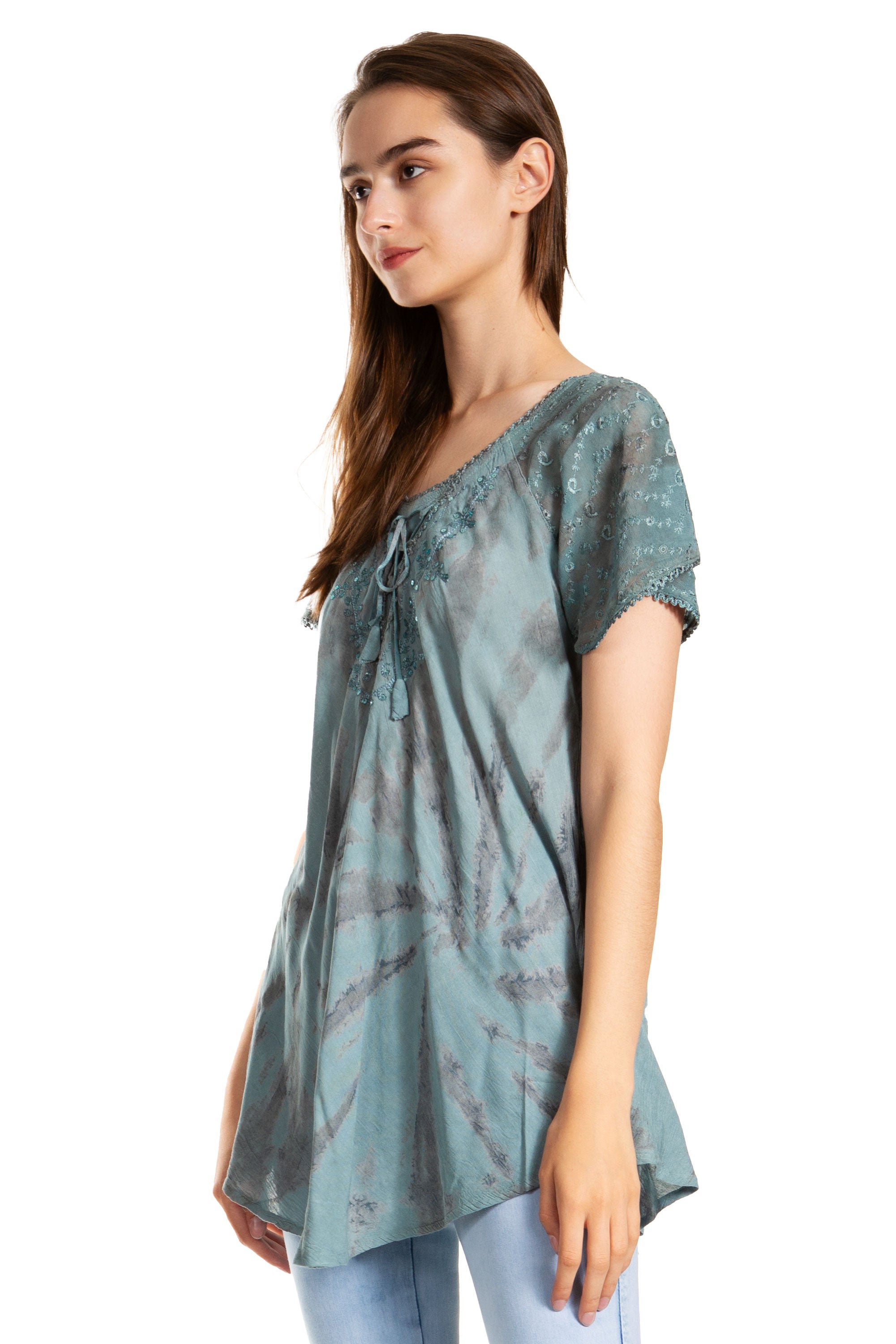 Woman wearing a light blue patterned top on a white background
