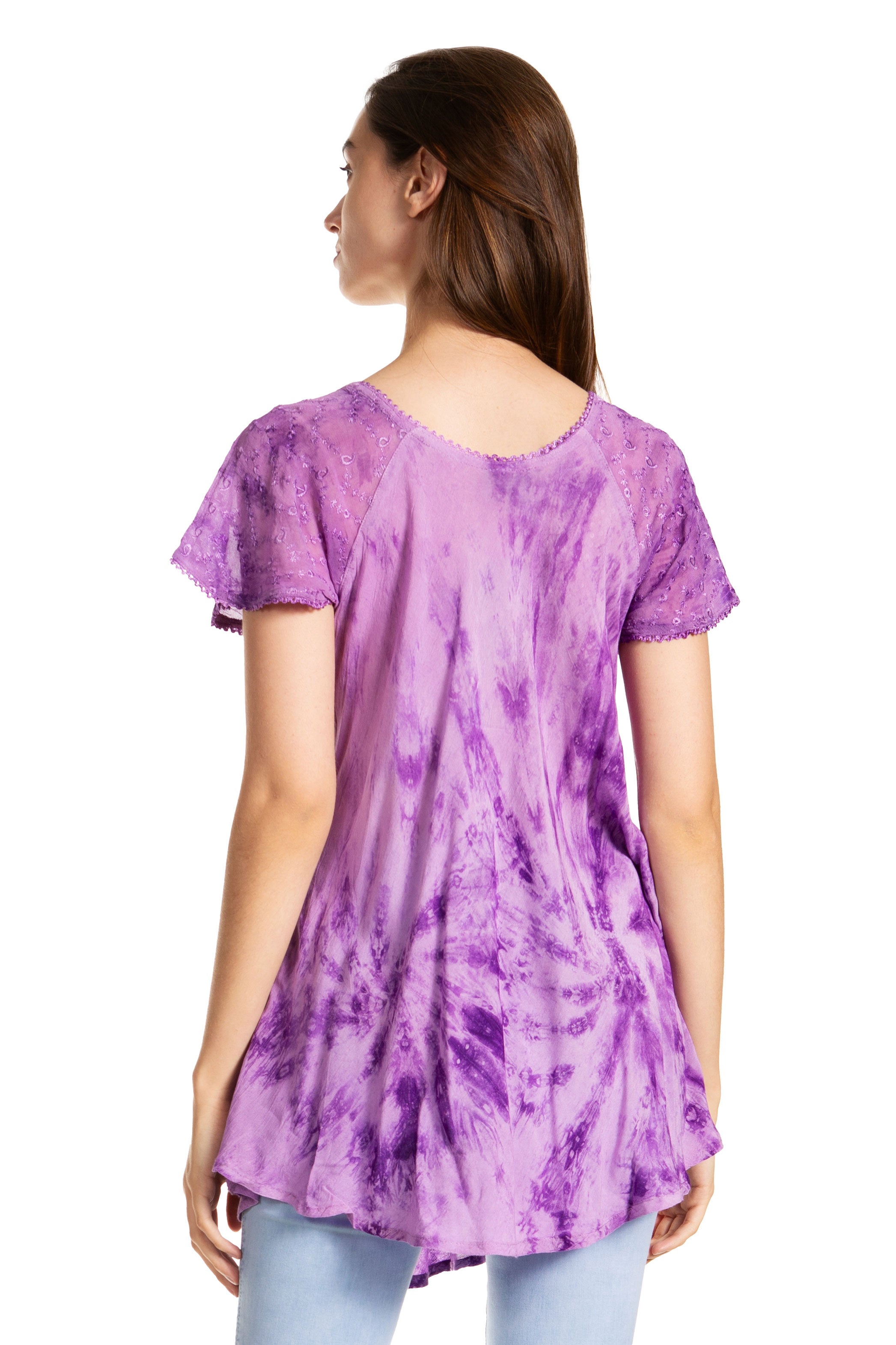Woman wearing a purple tie-dye tunic on a white background