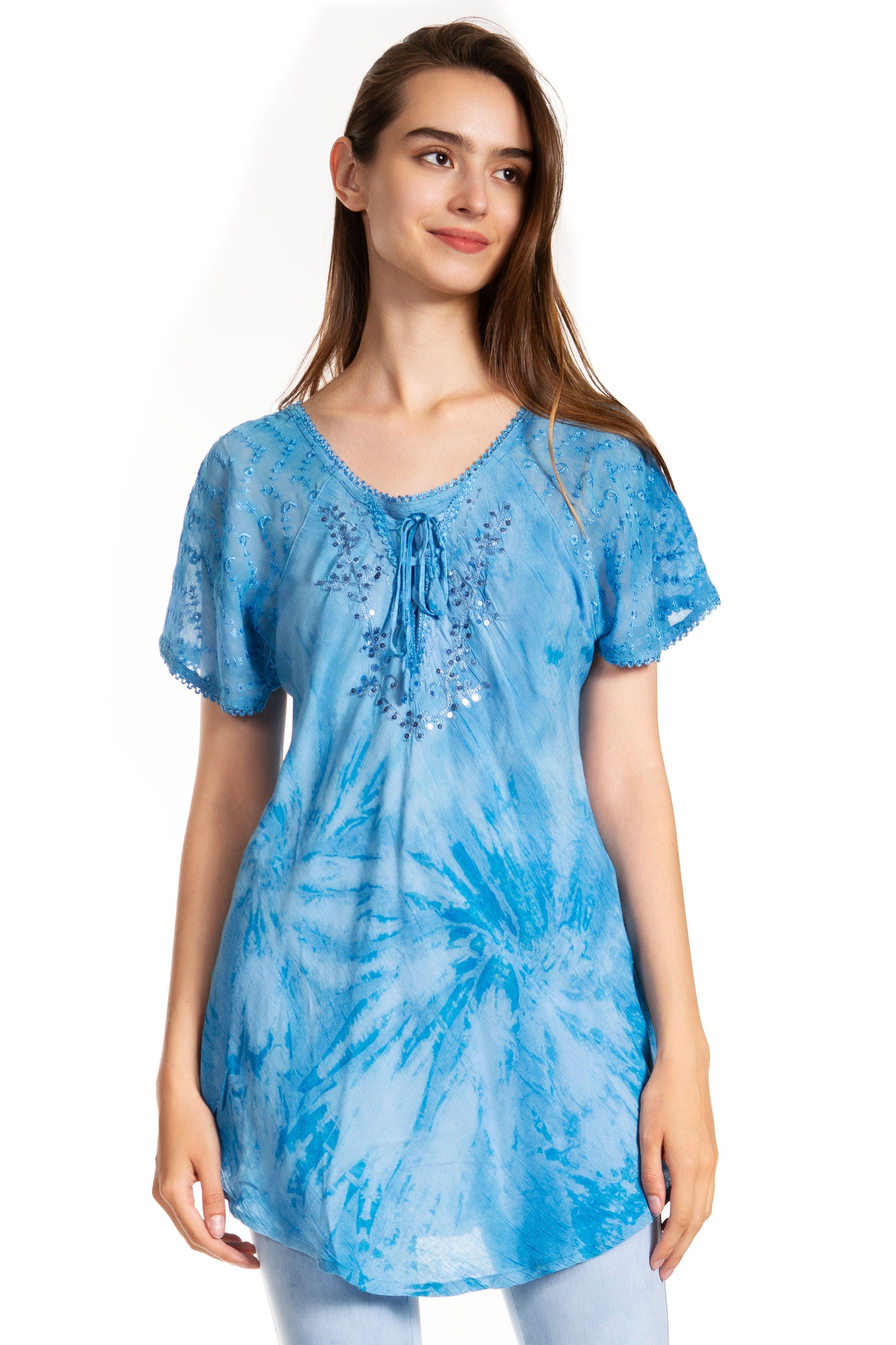Woman wearing a blue tie-dye tunic with lace details on a white background