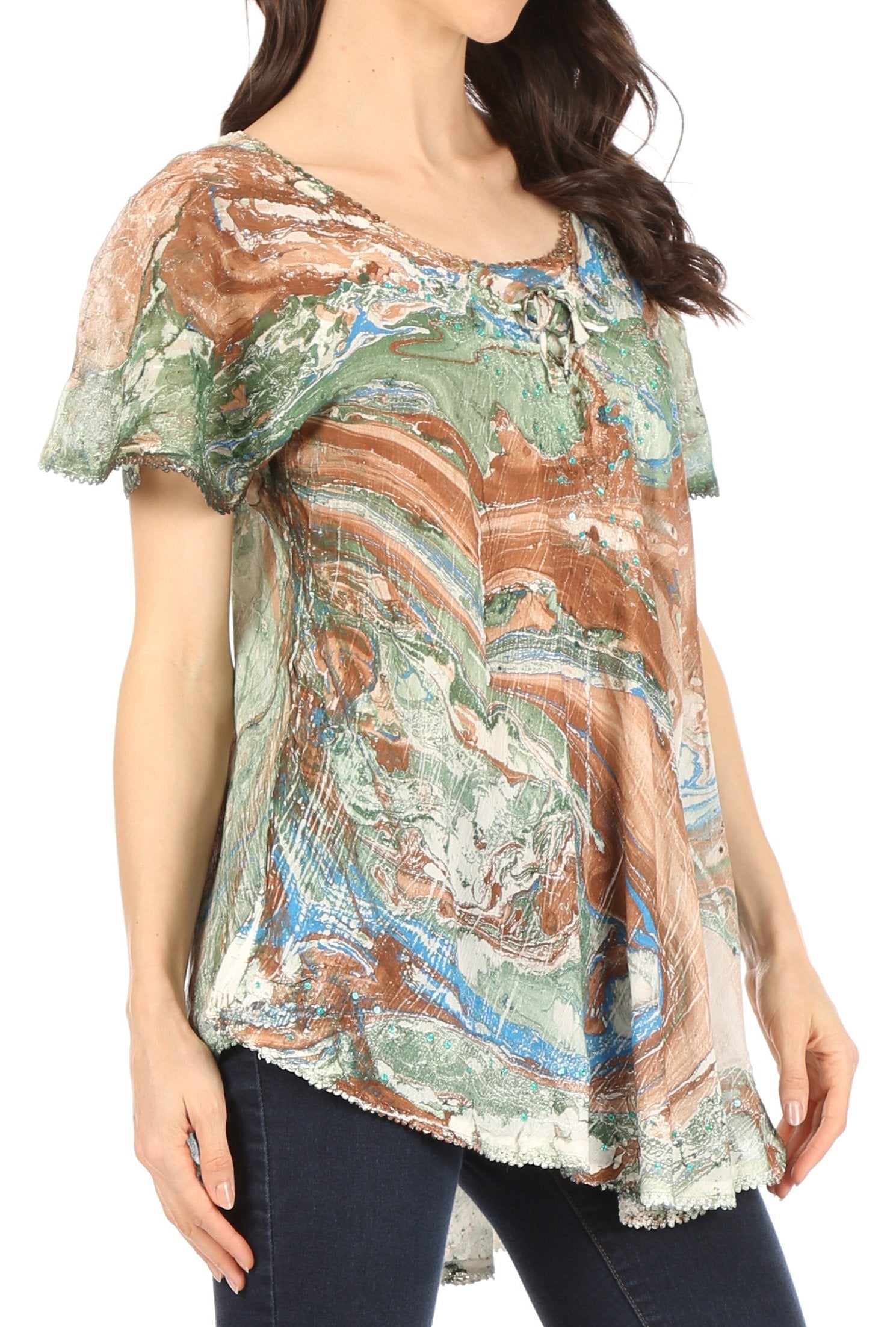 Woman wearing a colorful patterned blouse with a white background