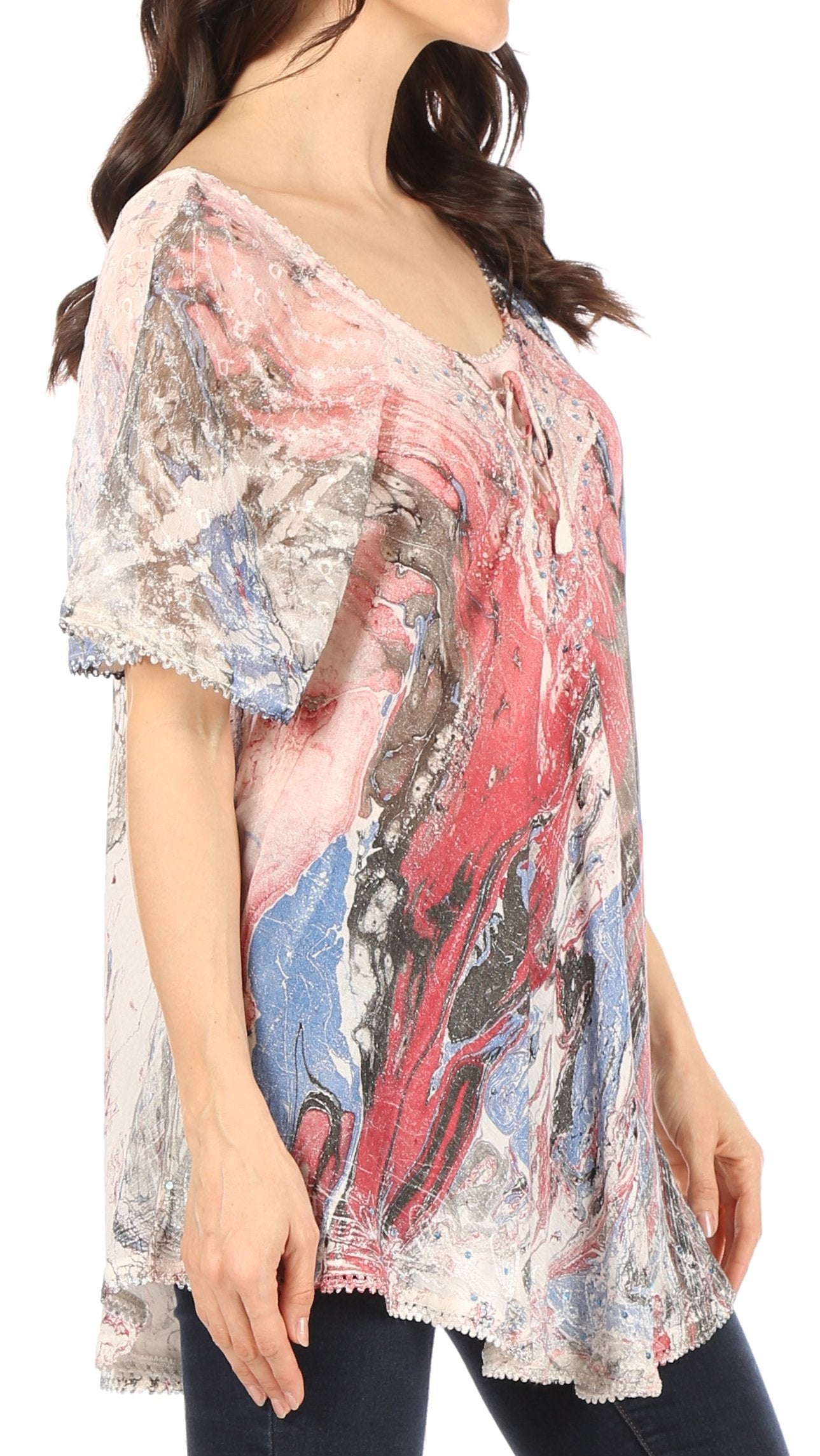 Woman wearing a colorful, sheer blouse with a white background