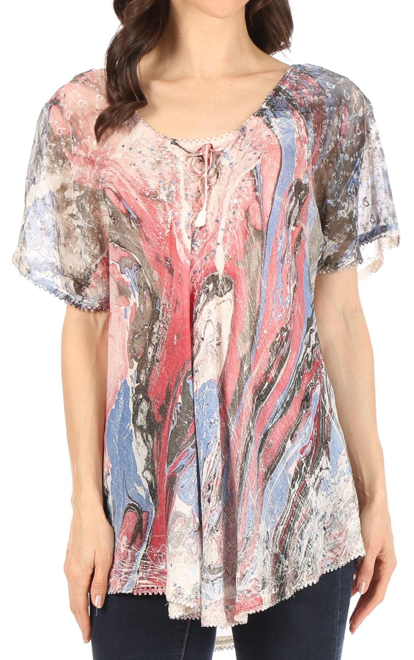 Woman wearing a colorful patterned blouse with short sleeves.