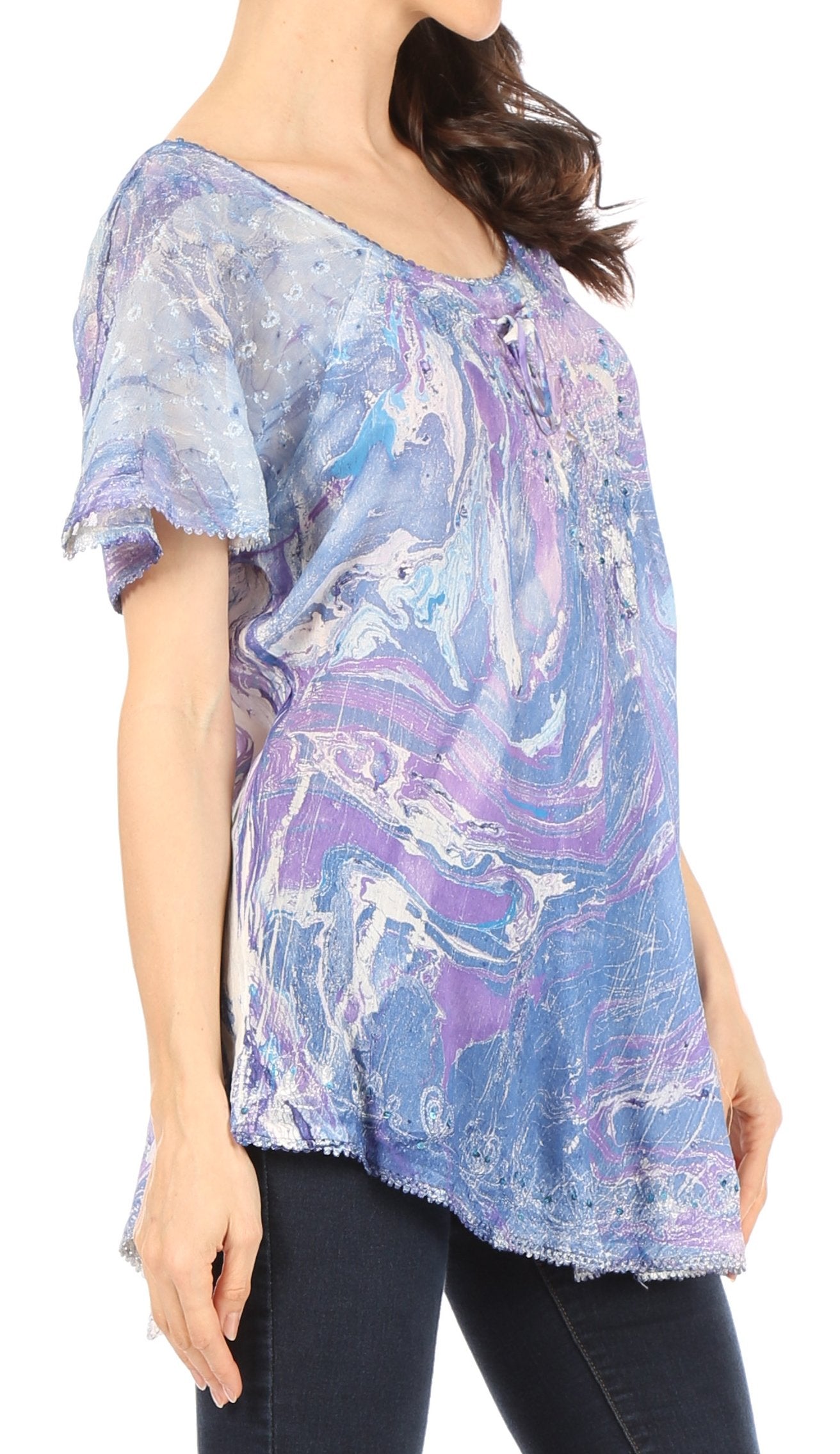 Woman wearing a colorful, patterned blouse with short sleeves on a white background