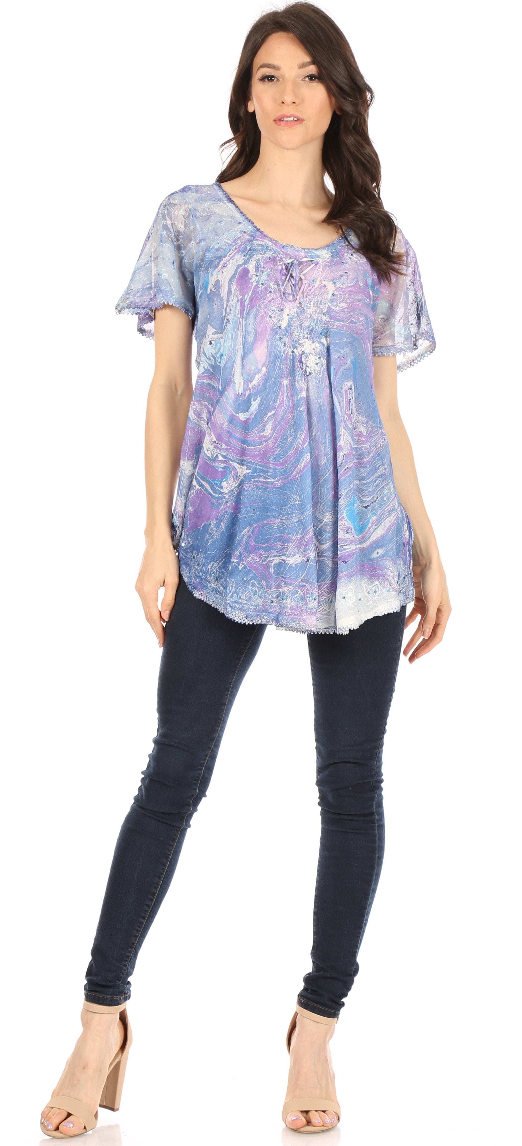 Woman wearing a blue and purple patterned top with dark jeans