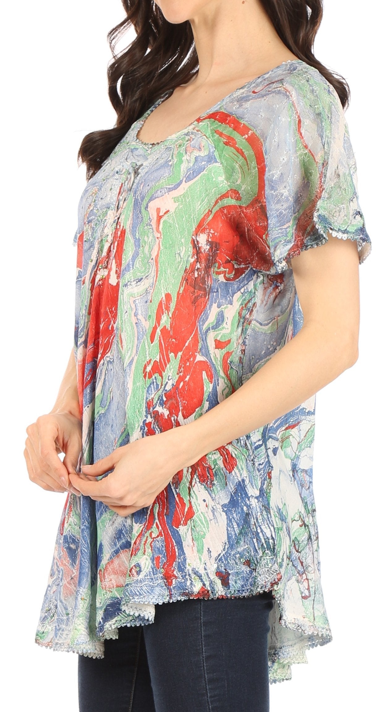 Woman wearing a colorful patterned top with short sleeves.