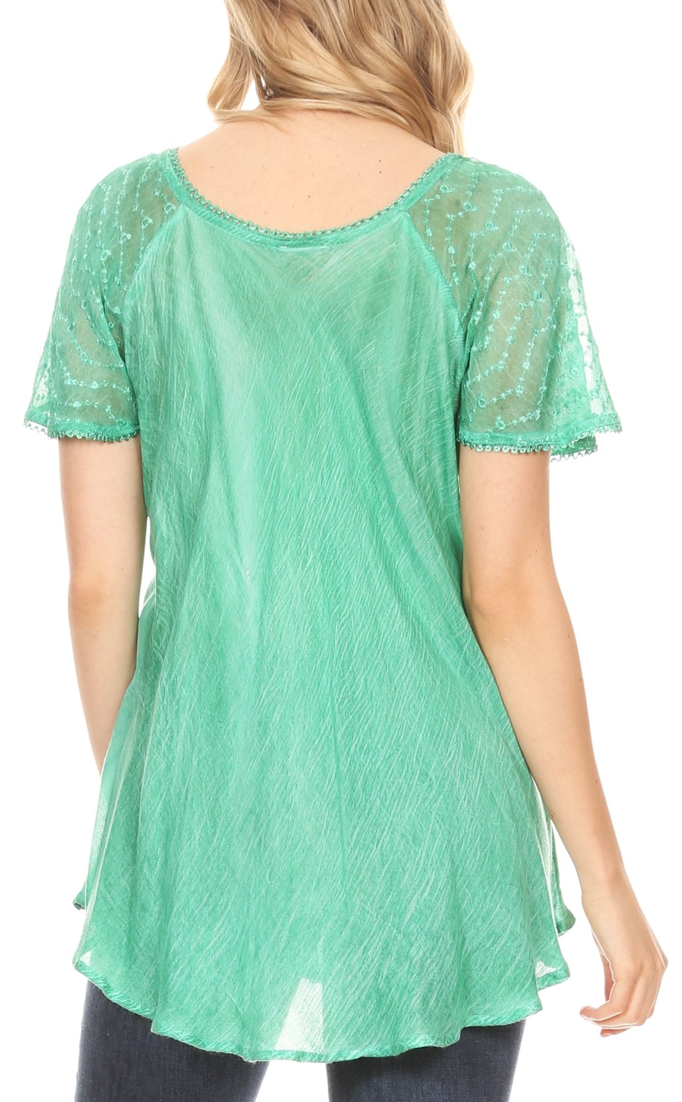 Green lace top worn by a person on a white background