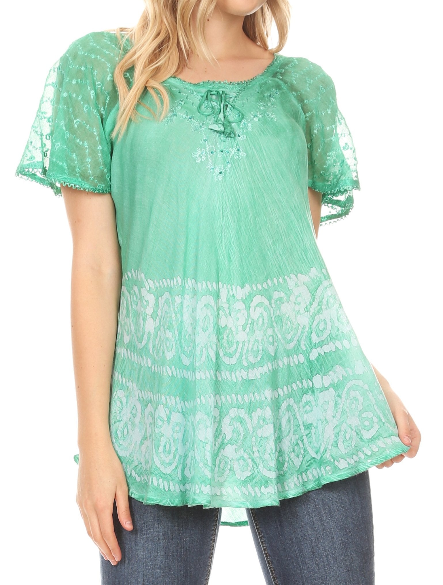 Green lace top worn by a person on a white background