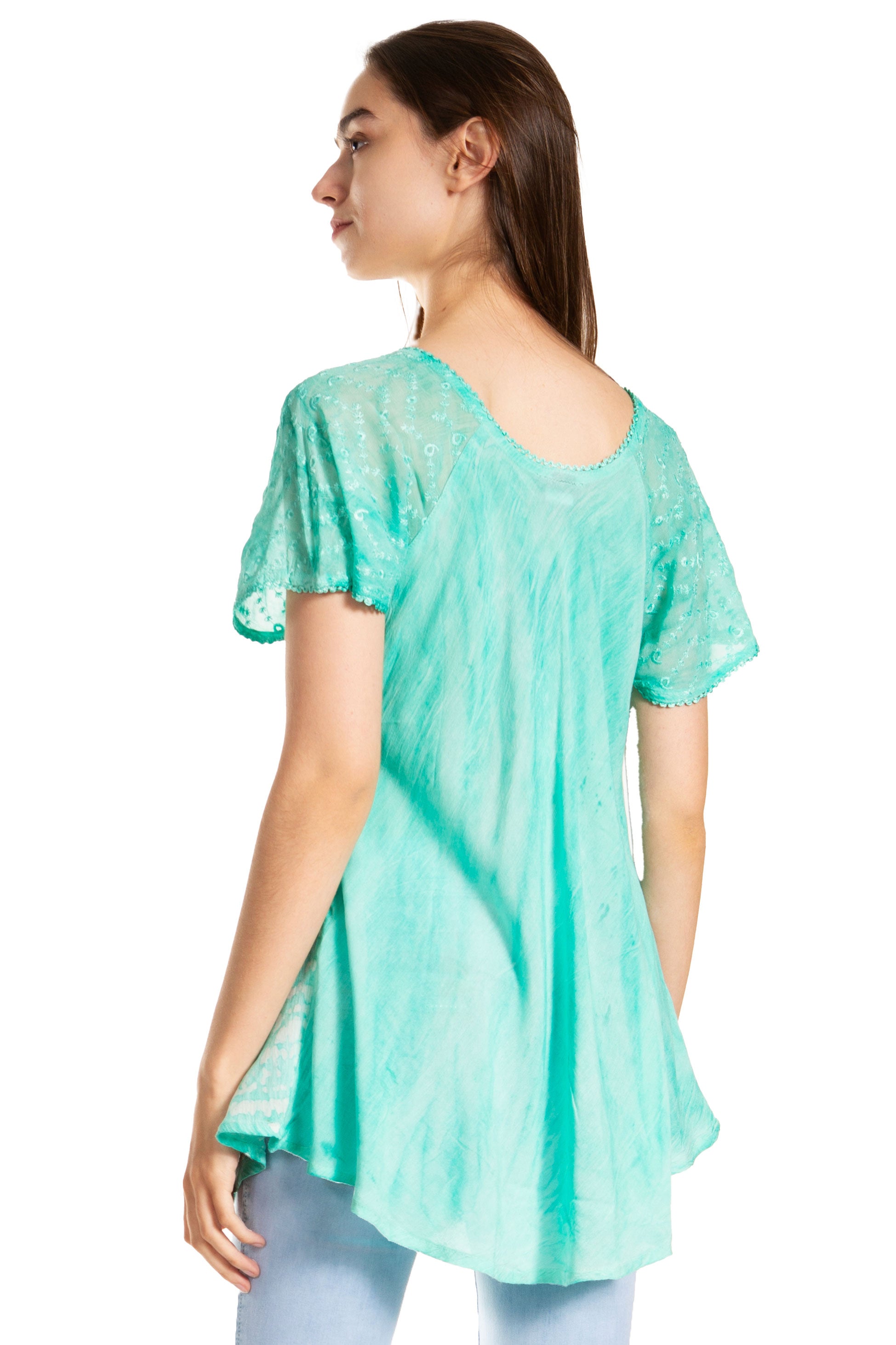 Woman wearing a light green tunic with a white background
