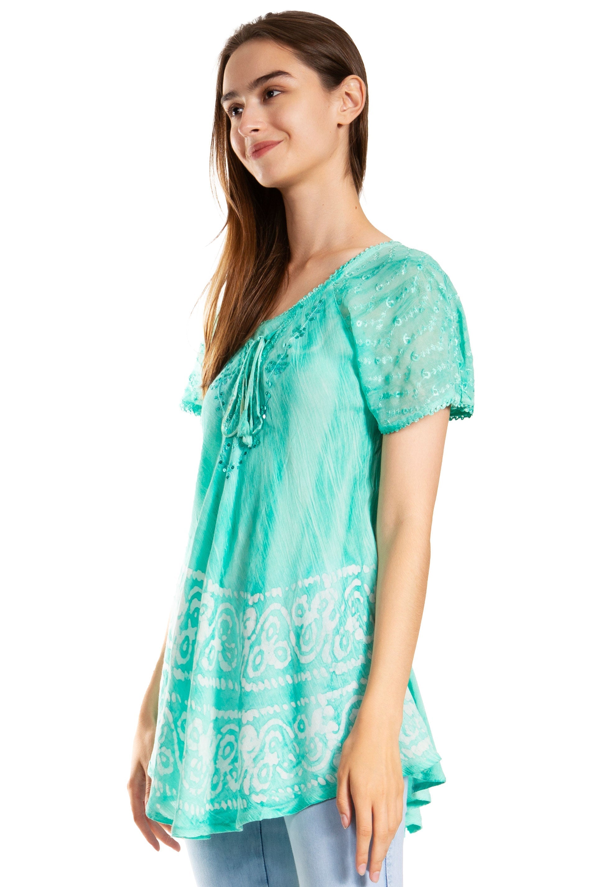 Woman wearing a teal patterned blouse on a white background