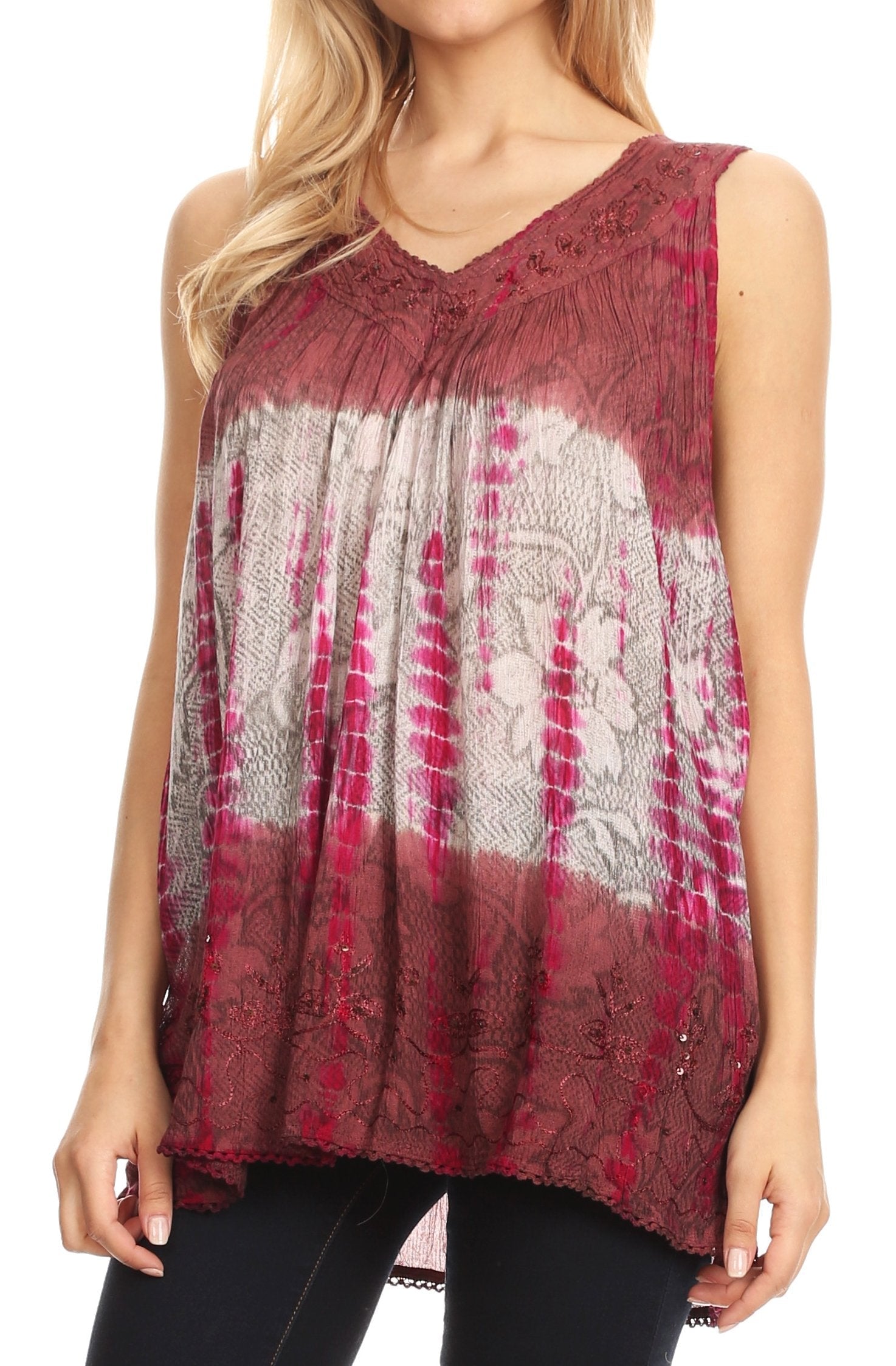 Woman wearing a sleeveless, patterned top with a maroon and white design.