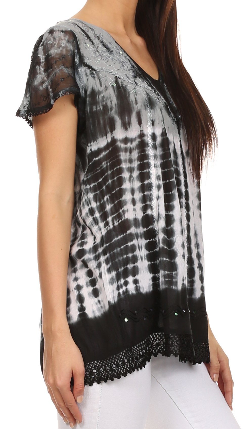 Woman wearing a black and white tie-dye top with lace details on a white background