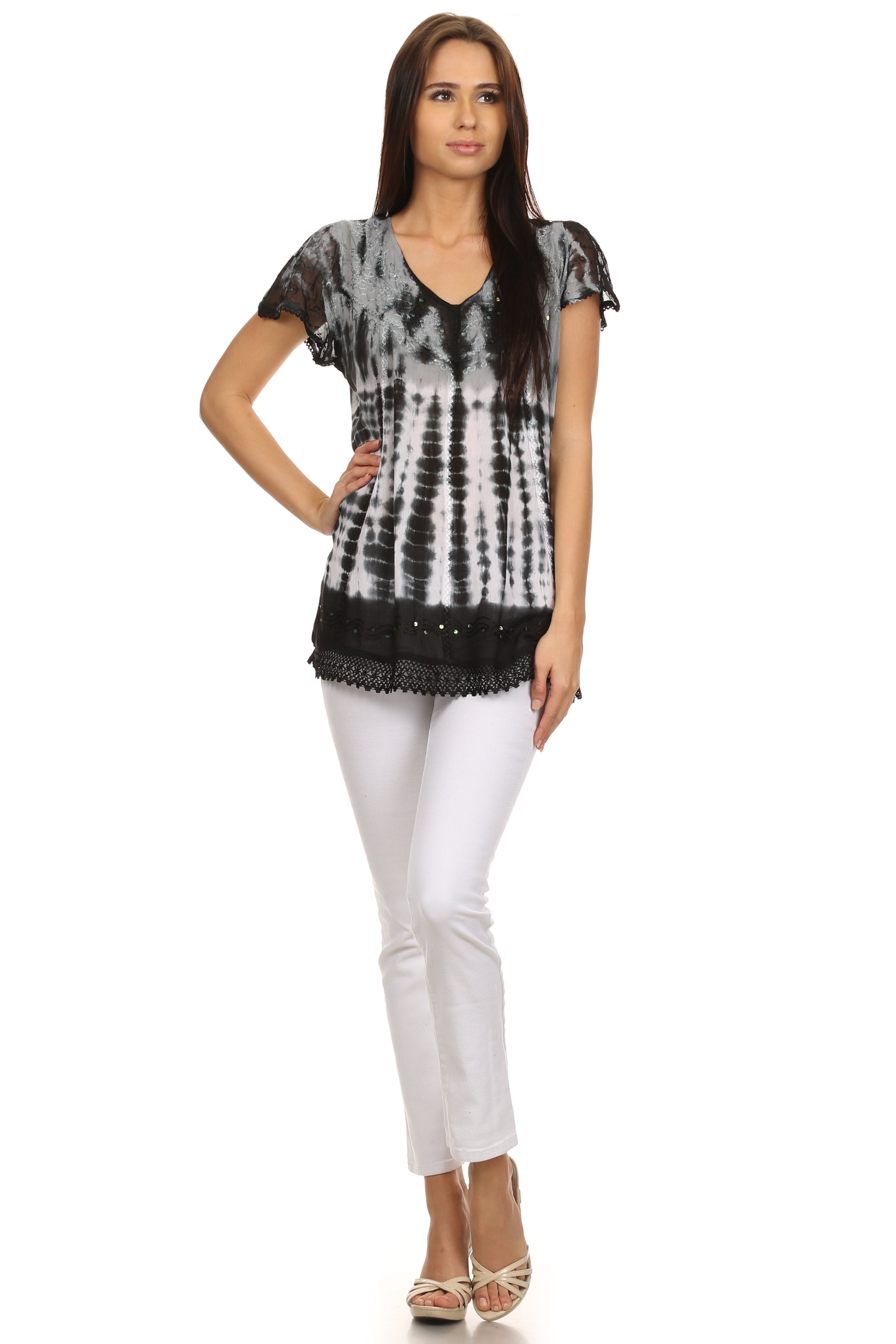 Woman wearing a black and white tie-dye top with lace details on a white background