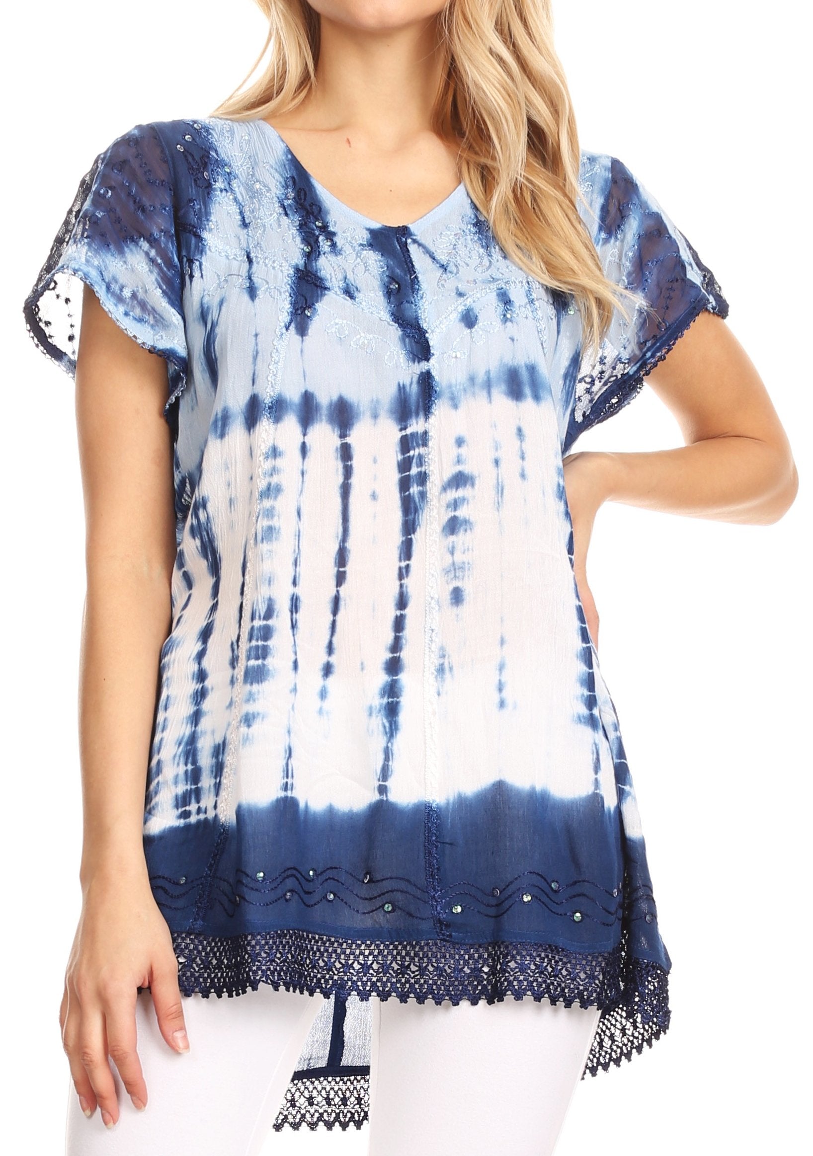 Woman wearing a blue and white tie-dye top with lace details on a white background