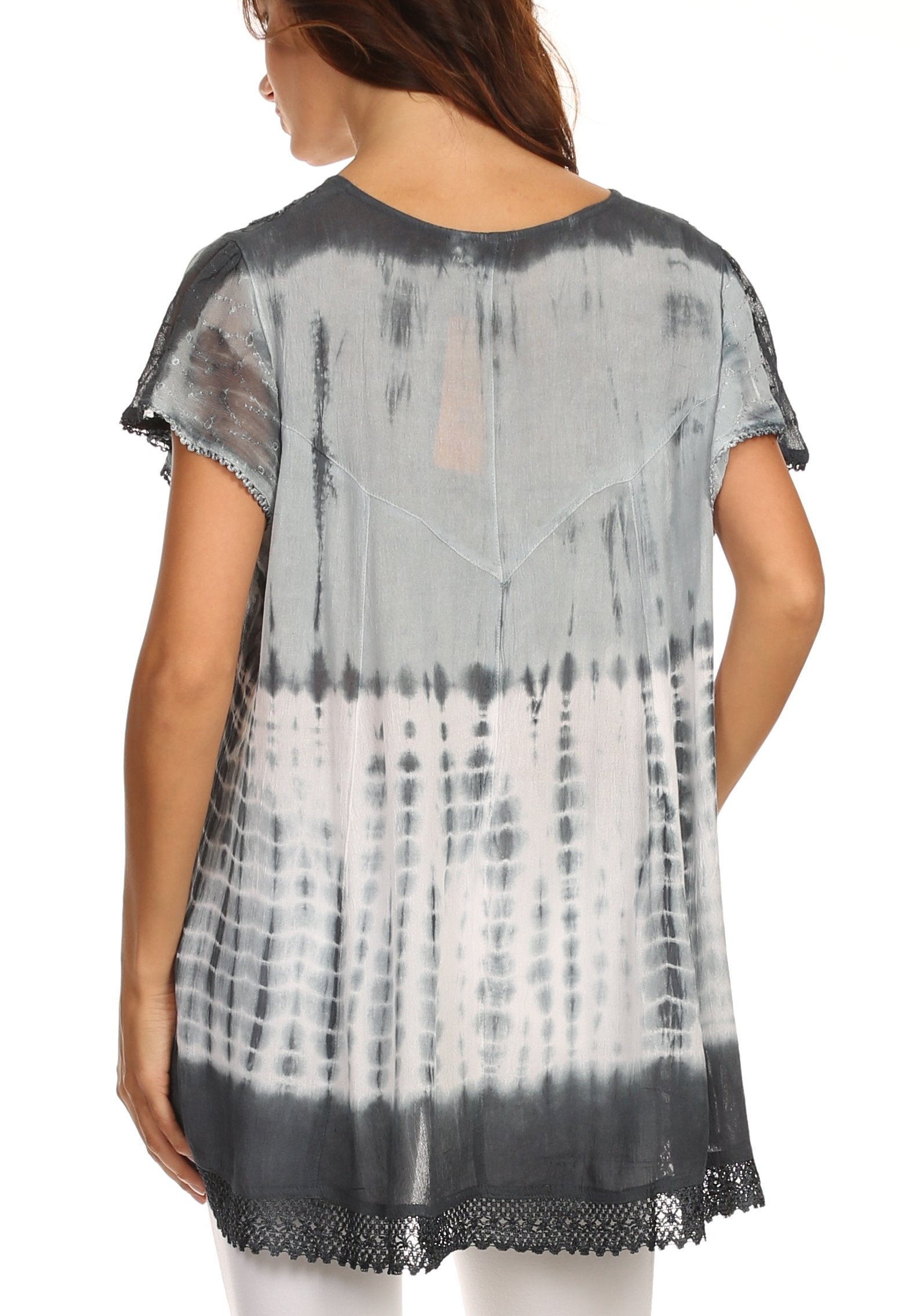 Woman wearing a black and white tie-dye shirt with lace trim on a white background