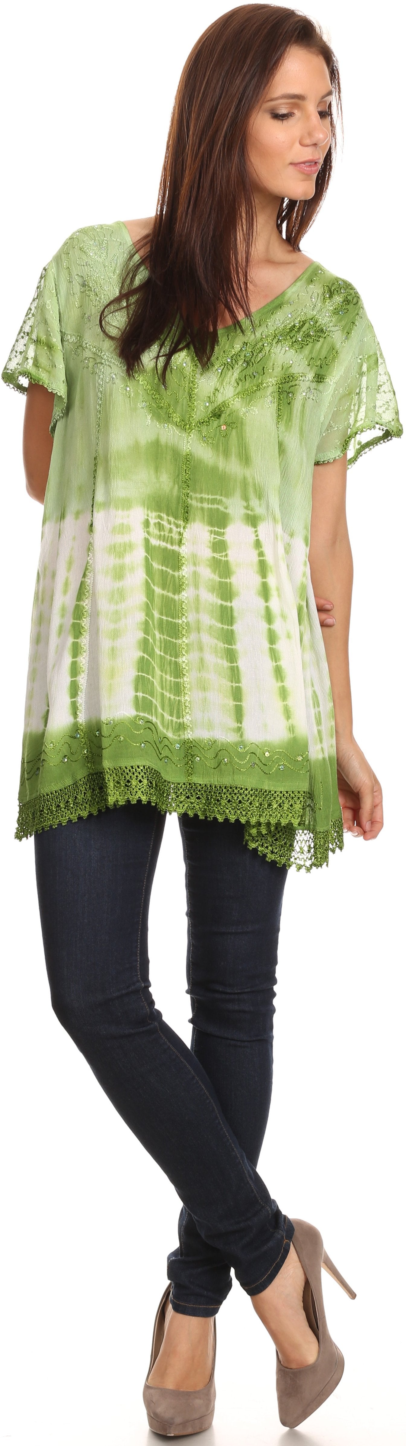 Woman wearing a green and white tie-dye top with black pants.