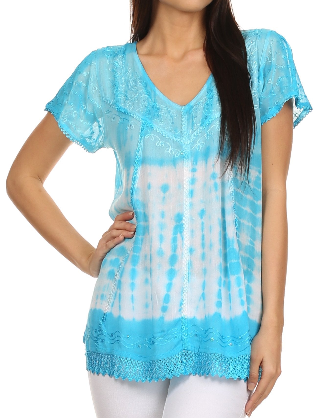 Woman wearing a blue and white tie-dye top with lace details on a white background