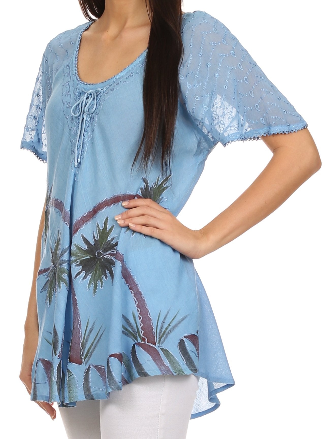 Woman wearing a blue lace top with palm tree design on a white background